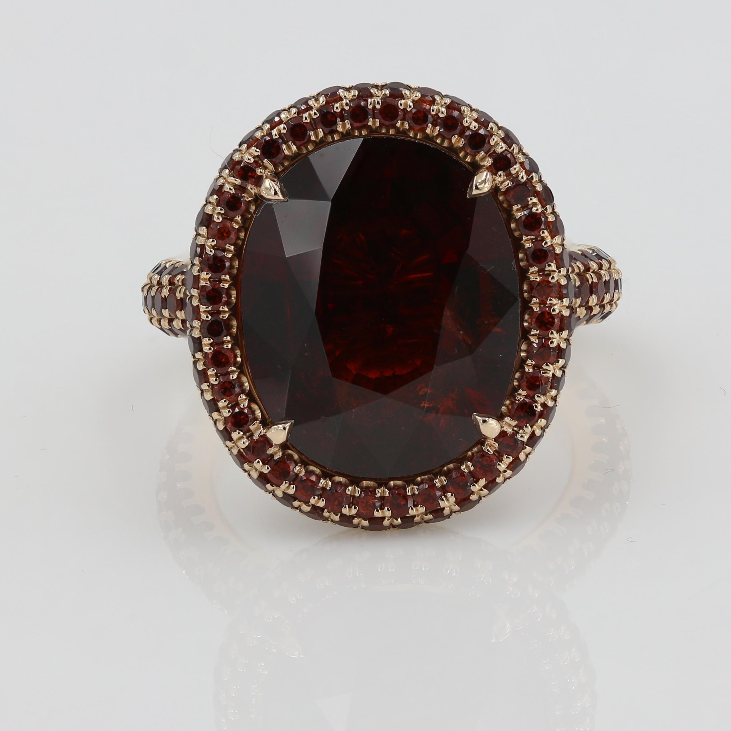 This “Bubble” cocktail ring in 18kt. Rose gold features an impressive 9.13cts. fine Oval cut Garnet. 266 small cut round garnets frame the large oval center and continue all the way around the band in a classic eternity style setting weighing
