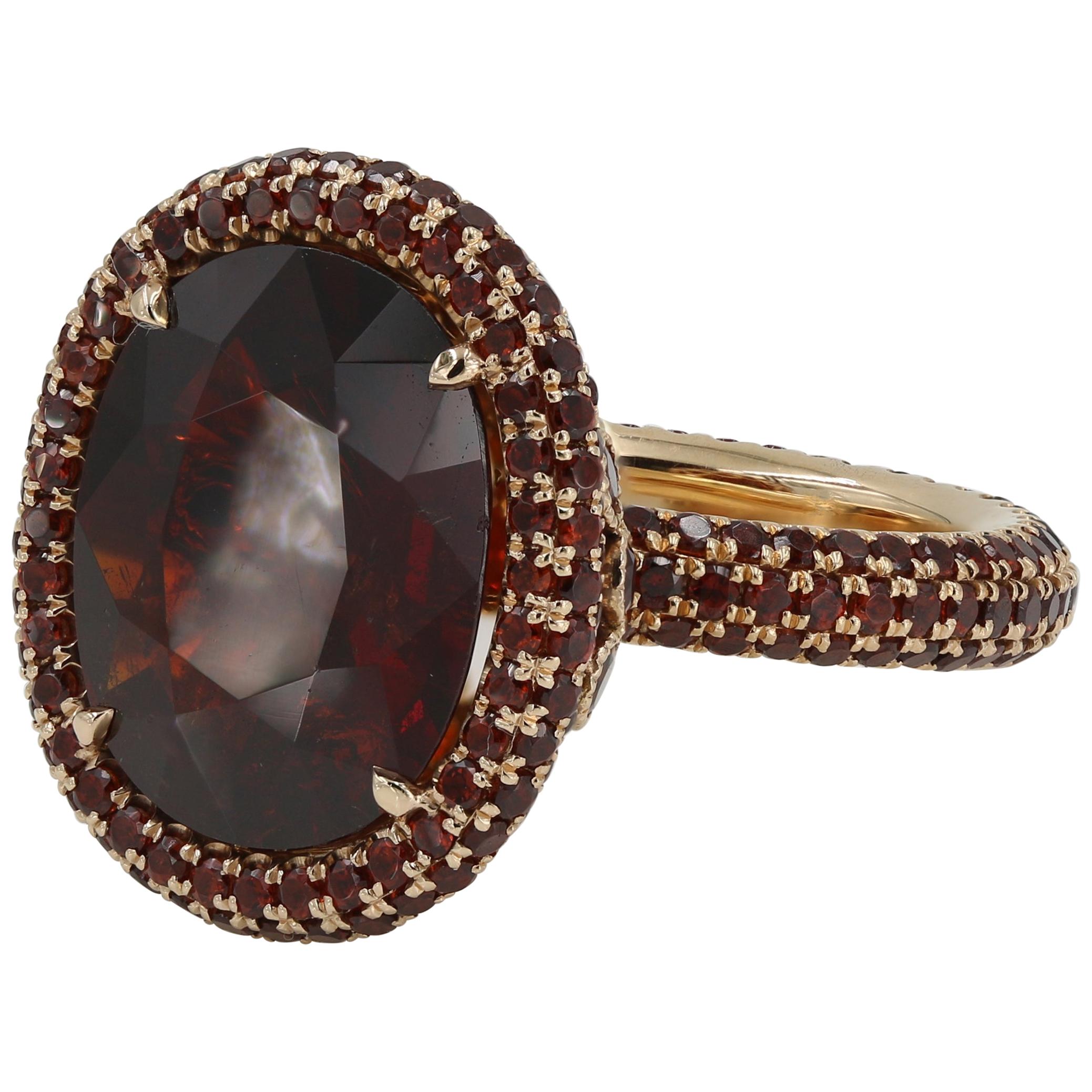 9.13 Carat Oval Cut Garnet with Small Round Cut Garnets in 18 Karat Gold Ring For Sale