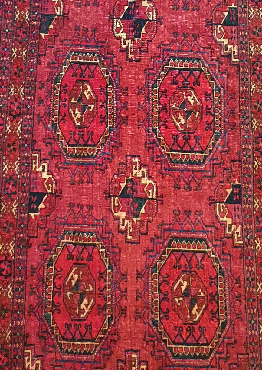914 - Beautiful Turkmen from the end of the 19th century for horse or Chuval cover, with a nice Bukhara design and natural red field colors, finely hand-knotted with woolen velvet on a wool foundation.