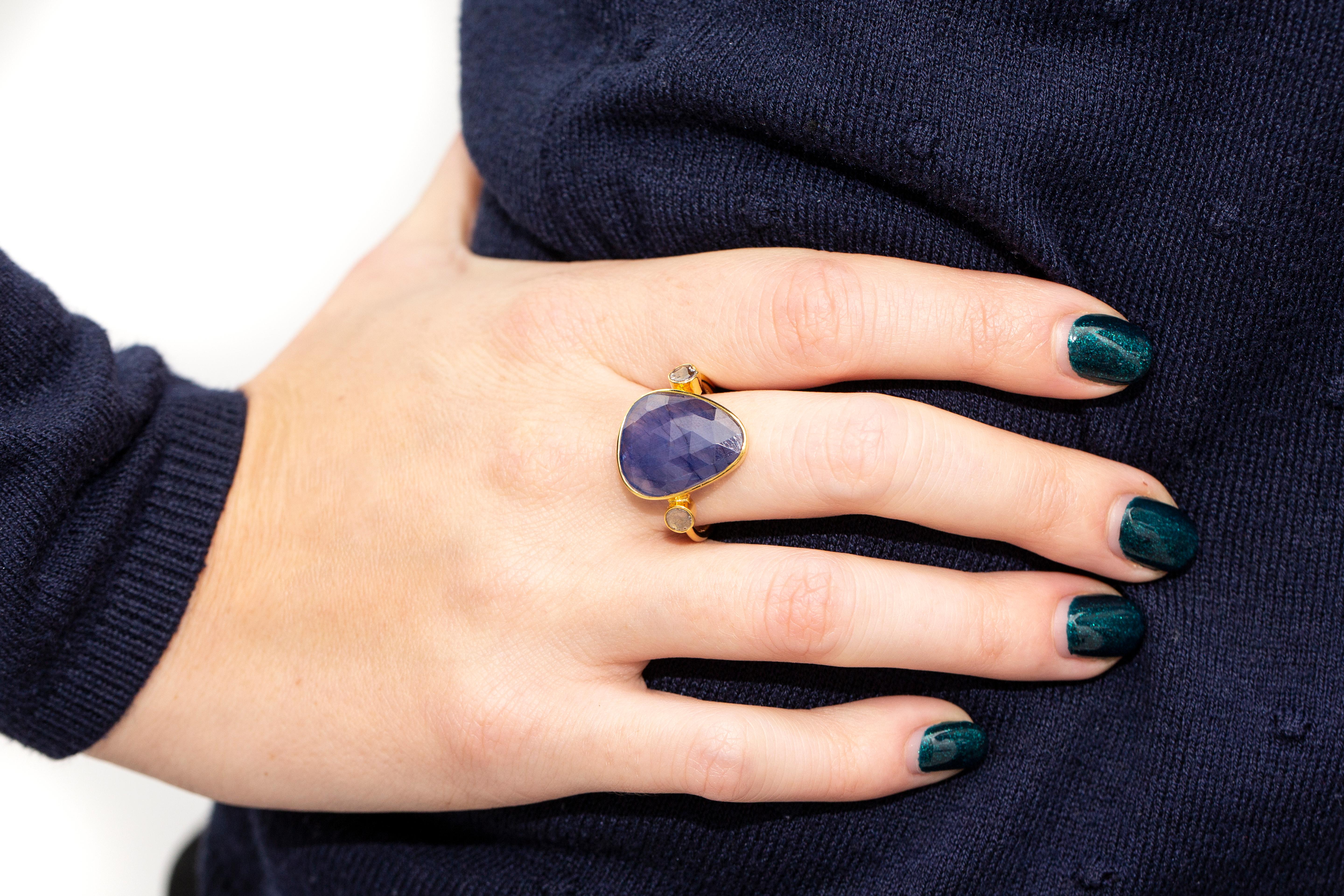 Cette magnifique bague en saphir bleu de 9,00 carats est ornée de deux tranches de diamant de 0,15 carat, une de chaque côté, en or jaune 18 carats. Cette bague unique de 3 pierres, saphir bleu et diamant taille rose, est parfaite pour toute
