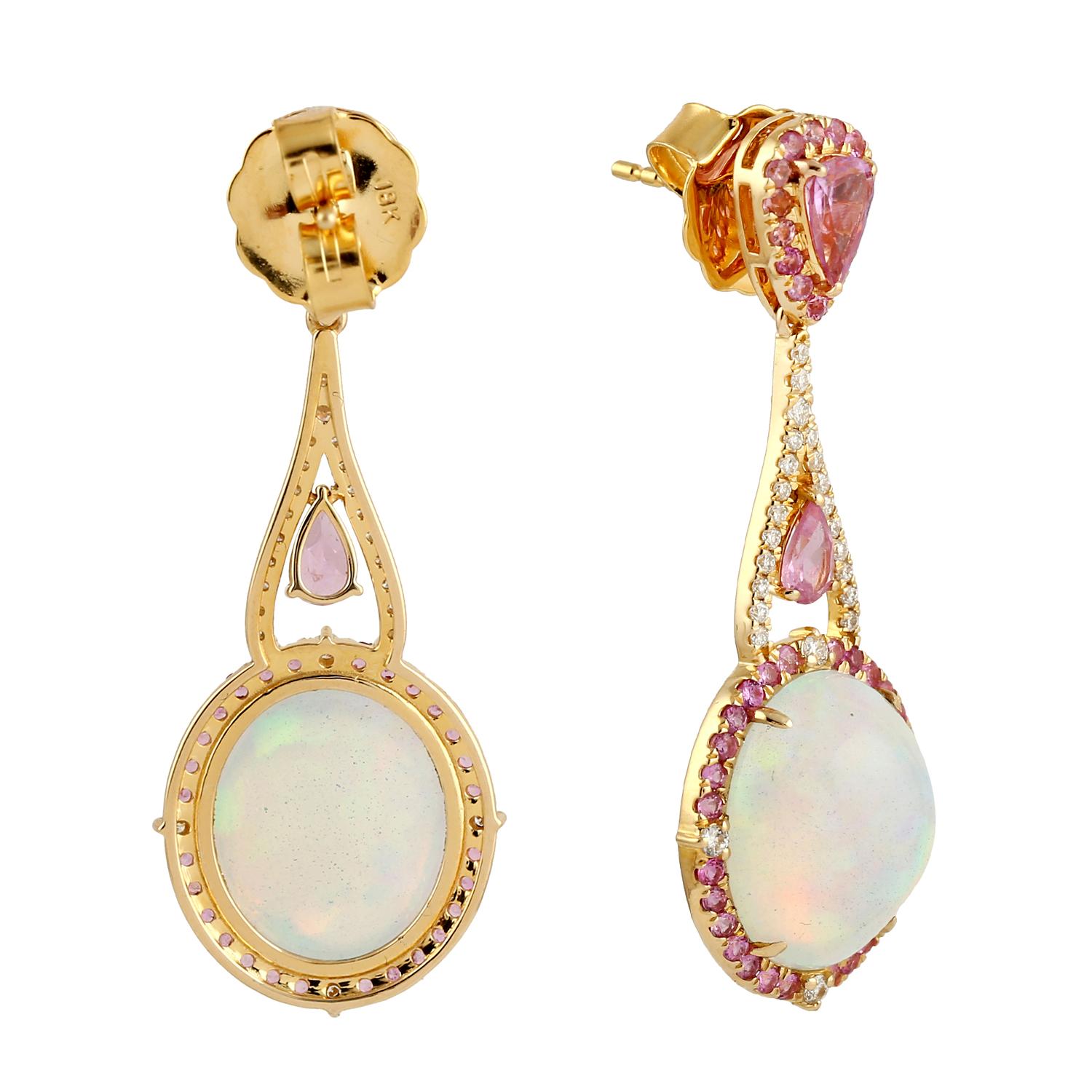 Cast in 14 karat gold. These earrings are hand set in 9.15 carats Ethiopian opal, 2.5 carats pink sapphire and .38 carats of sparkling diamonds. Matching ring available.

FOLLOW MEGHNA JEWELS storefront to view the latest collection & exclusive