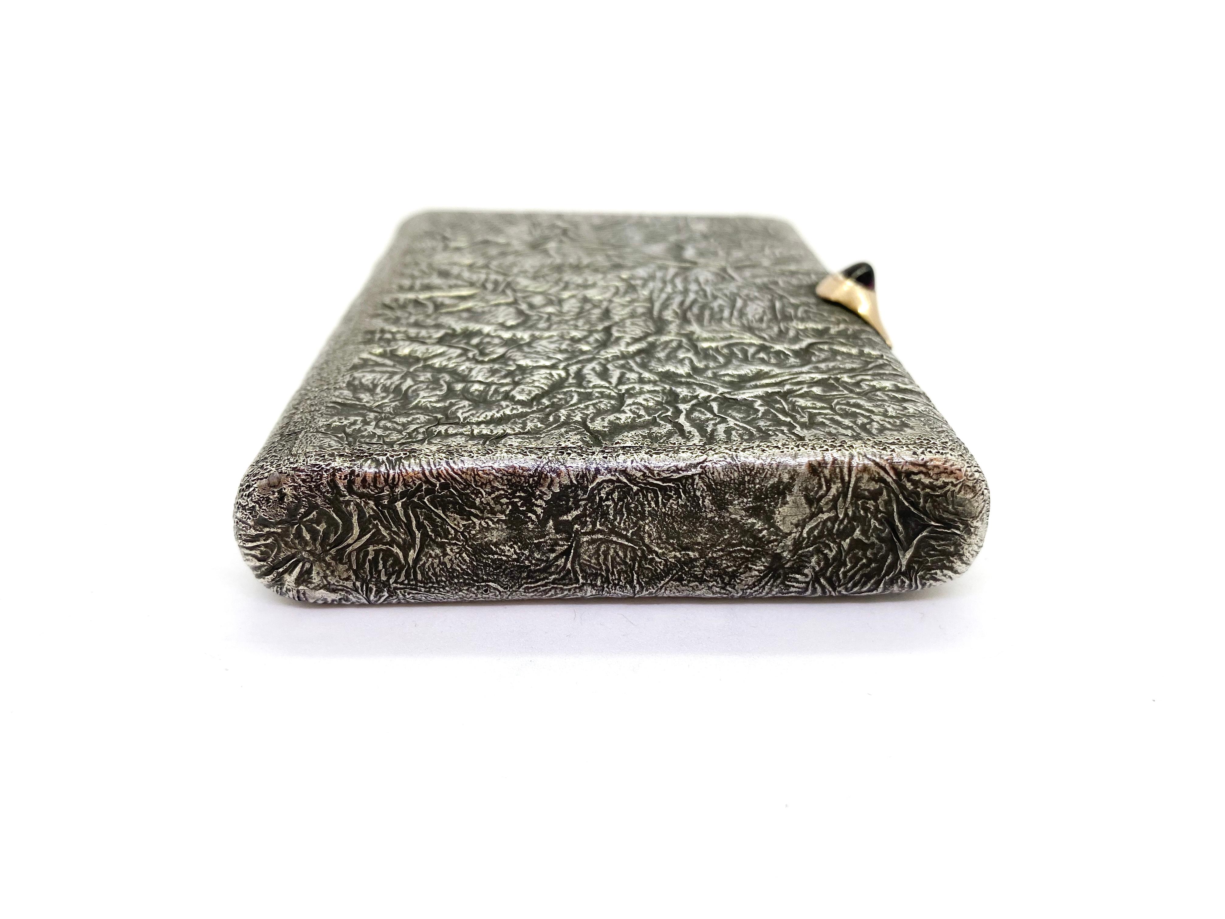 A samodorok silver 
916 Silver Inside Gilded Soviet Union Russia Cigarette Case 
Height 9.9cm, width 7.5cm, depth 1.7cm
Silver Stamp 916 and Head
Age probably 1950s
Handle Gold and Red Round polished stone.
The stone may be Garnet or Ruby.
The