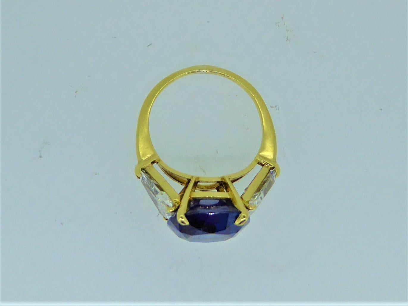 9.17 Carat Unheated Ceylon Blue Sapphire And Trilliant Diamond Three Stone Ring. The oval vibrant blue sapphire with Gubelin certificate, stating it to be from Sri Lanka and with no indications of heat treatment. Mounted in 18 carat yellow gold and