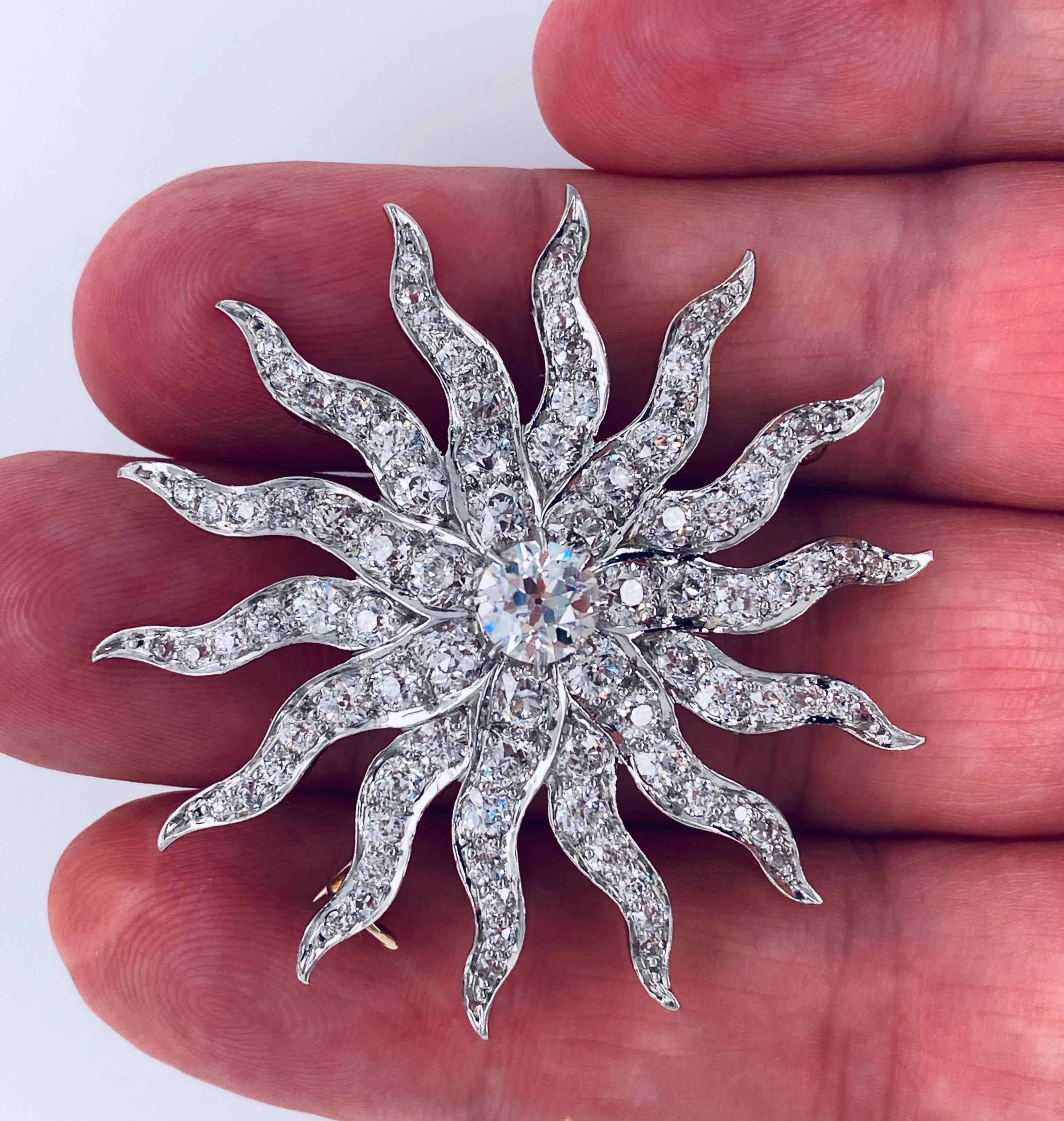 Offered here is an Antique Masterpiece, circa early 1900
A large sunburst handmade of platinum over 14kt yellow gold, about 2 inches in diameter.
Centered is a natural earth mined, old European cut diamond with a calculated weight of 1.18 ct set
