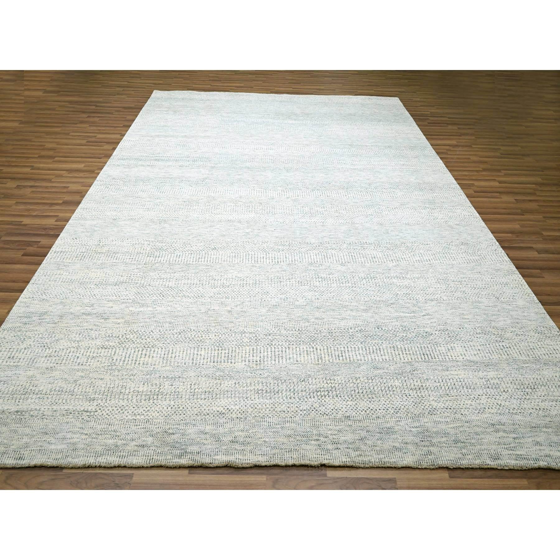 Pearl White, Modern Grass Design, Hand Knotted, Borderless, Soft and Vibrant Wool, Tone on Tone, Oriental Rug
Primary materials: Wool
Latex: No Pile 
height: 0.25 Inches
Style: Contemporary
Primary color: Ivory
Secondary colors: Gray, Black
Pattern:
