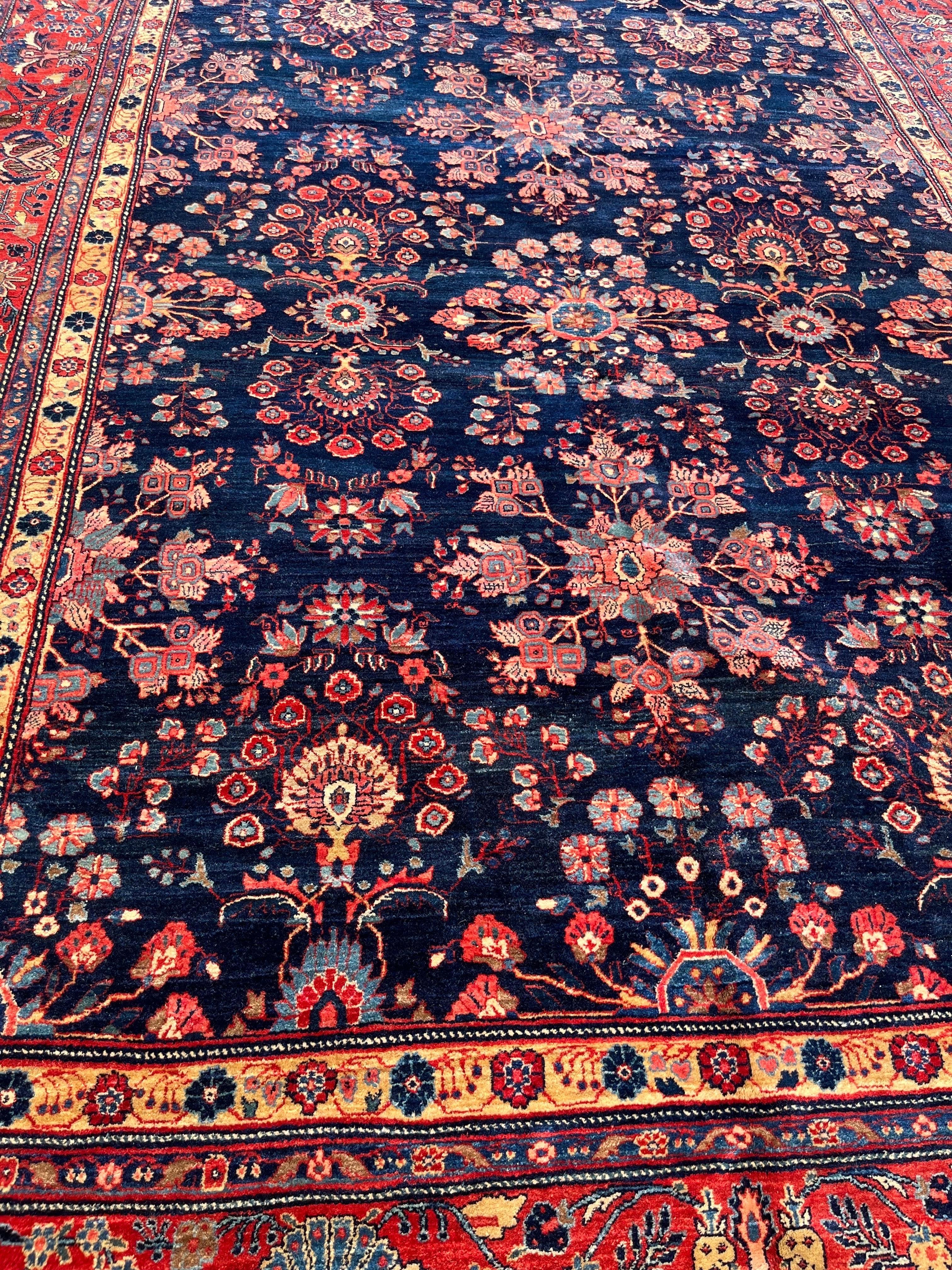 Very soft wool 9’1”x12’1”rug hand made in Persia over 100 years ago. Beautiful floral spray design on a rare blue field with a tomato red border. This carpet will bring a richness and elegance to any room. 