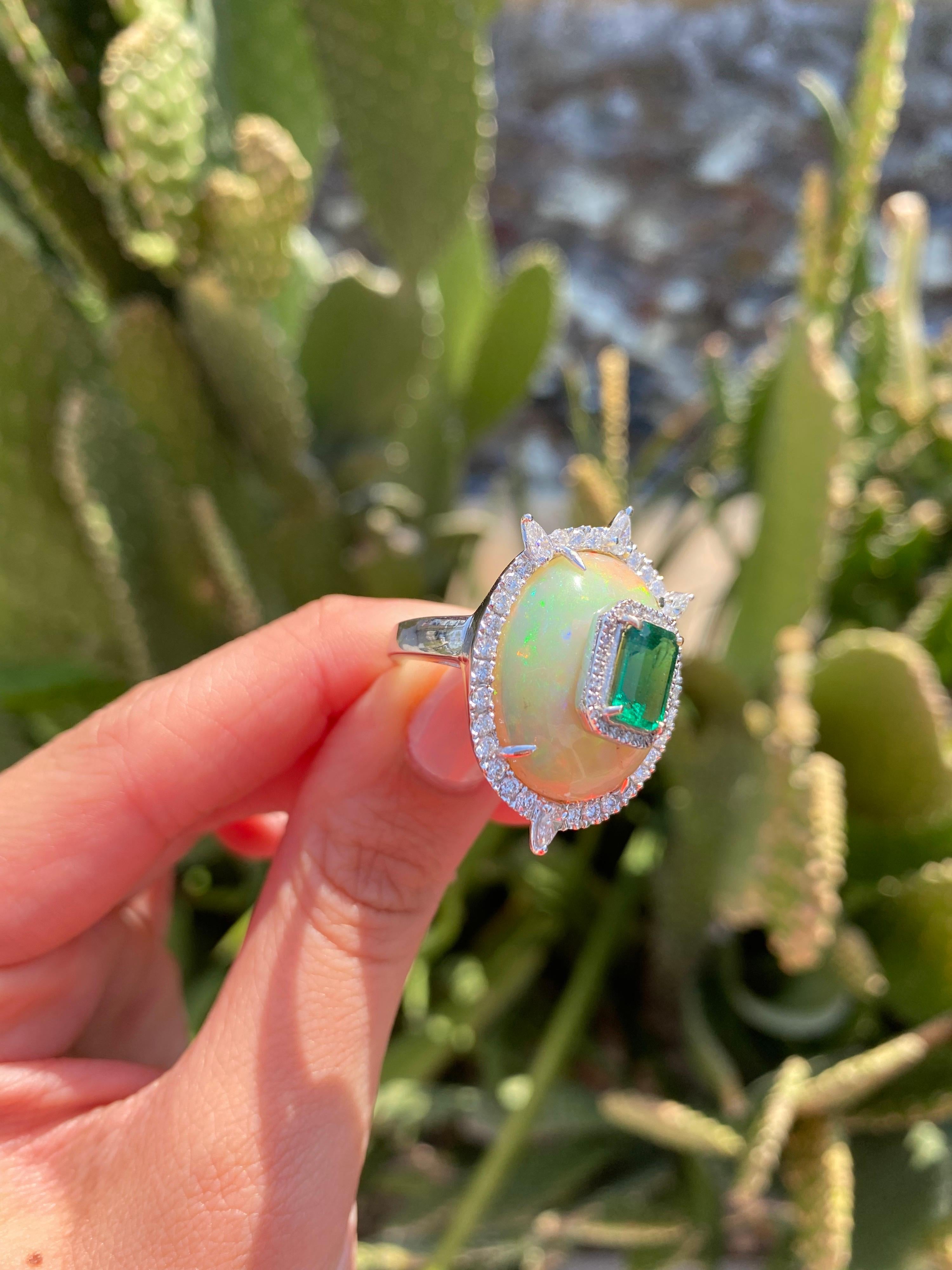A very unique 9.2 carat Ethiopian Opal with an absolutely stunning (no inclusion, great colour and luster) 1.87 carat Zambian Emerald, and White Diamonds. The stones are completely natural, and are set using solid 18K White Gold. 
Currently sized at