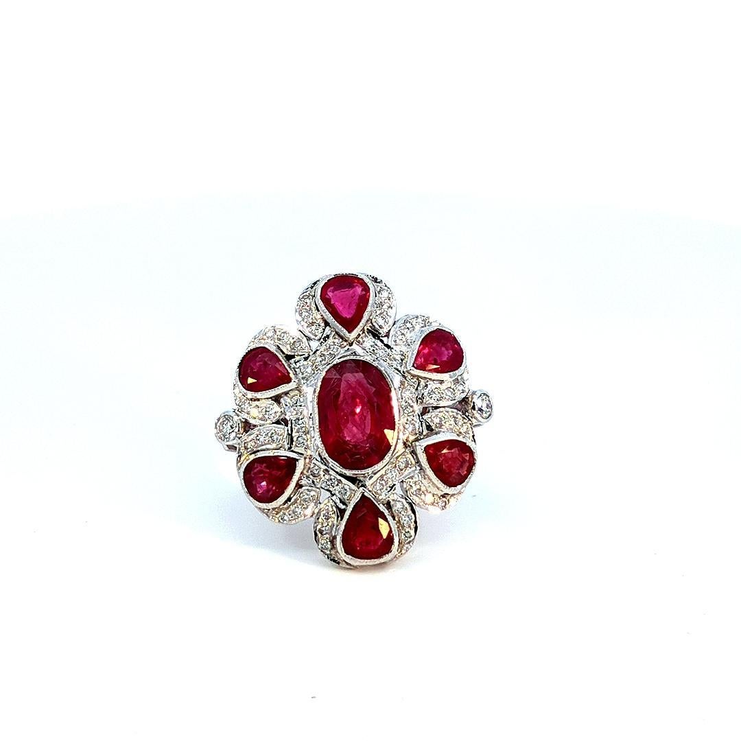 This striking ring features a captivating 9.2 Carat Ruby as its centerpiece. The oval cut of the ruby enhances its deep red hue, creating a bold and luxurious focal point. Surrounding the ruby are round-cut diamonds, totaling 1.0 Carat, which add a