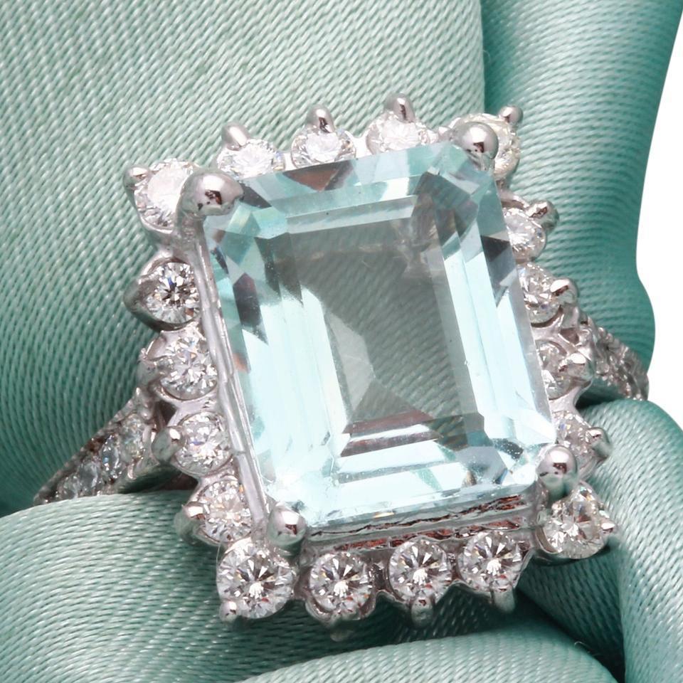9.20 Carats Natural Aquamarine and Diamond 14K Solid White Gold Ring

Total Natural Emerald Cut Aquamarine Weights: Approx. 8.00 Carats

Aquamarine Measures: 12 x 10mm

Aquamarine Treatment: Heating

Natural Round Diamonds Weight: Approx. 1.20