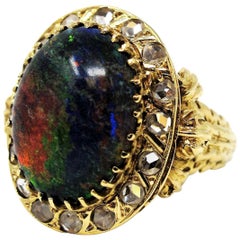 Retro 9.21 Carat Oval Cabochon Black Opal and Diamond Halo Cocktail Ring 14 Karat Gold