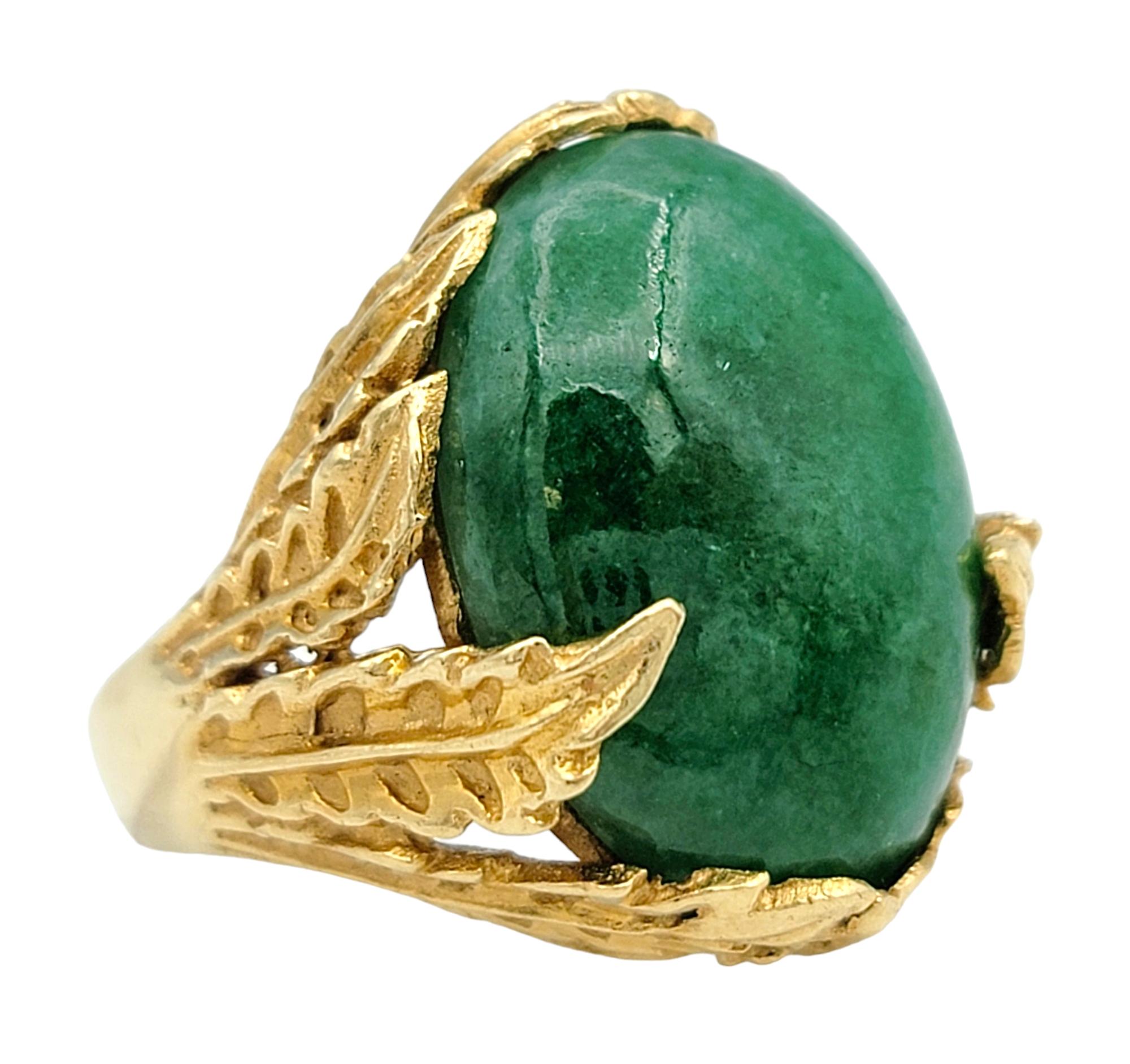 Ring Size: 4

Experience the timeless elegance of this captivating 9.22 carat cabochon green jade ring. This exquisite piece showcases a lush, green jade stone, its smooth cabochon cut highlighting the gem’s natural beauty and depth. Encircling the