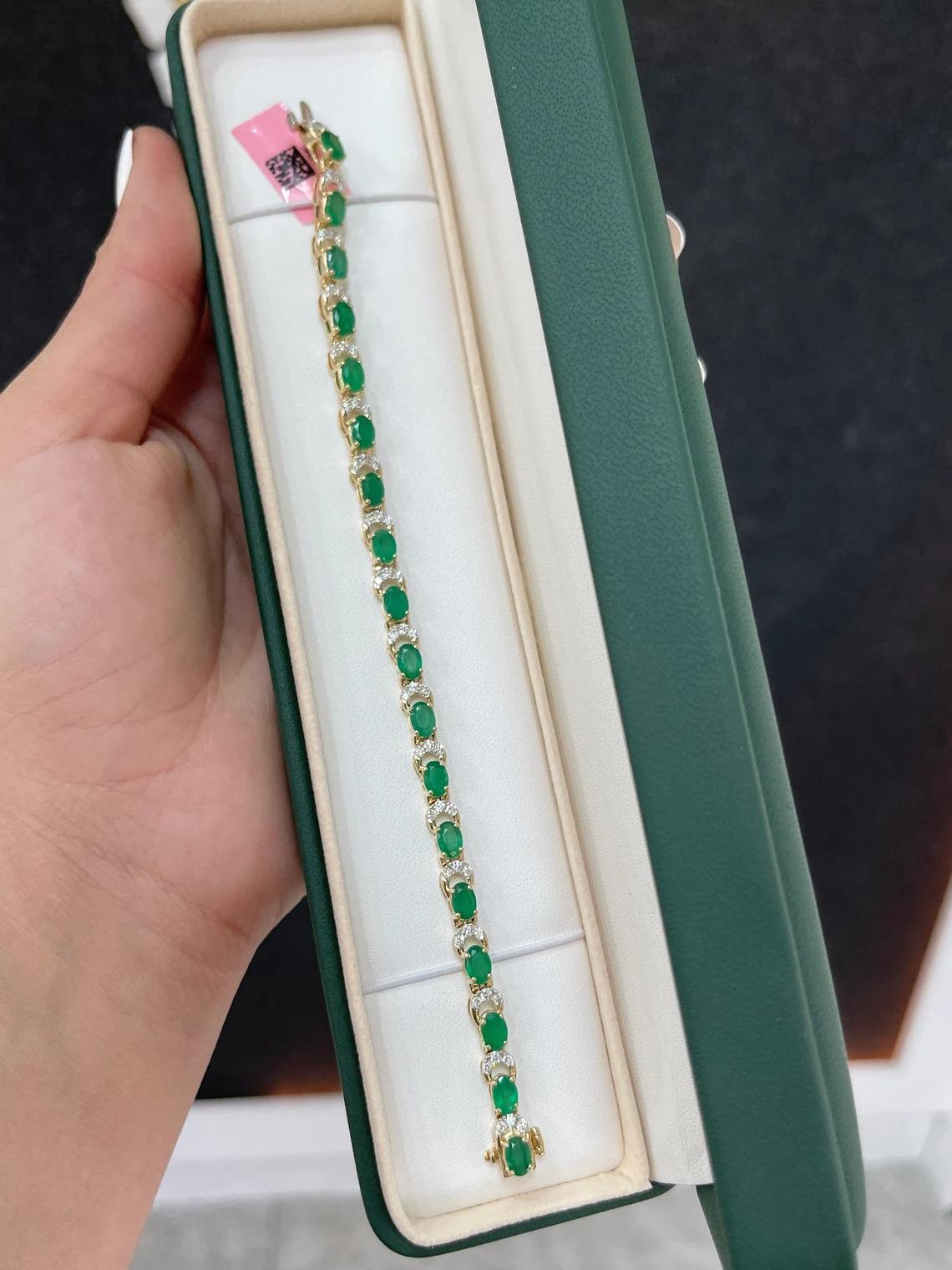 A gorgeous emerald and diamond bracelet. This remarkable piece features almost ten full carats of natural emeralds and diamonds. Eight carats of beautiful, lush, rich, dark green emeralds cut into the shape of an oval and showcase very good luster
