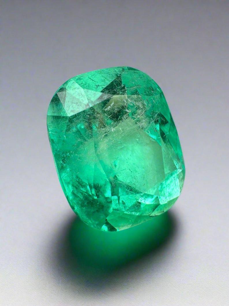 Stone: Emerald
Weight: 9.23-carats
Shape: Cushion Cut
Clarity: Transparent to Semi-Transparent
Luster: Very Good
Color: Medium Yellowish Green
Measurements: 14.08mm x 11.92mm x 9.65mm
Geographic Origin: Colombia
Treatment: Natural, Oil

Comments:
