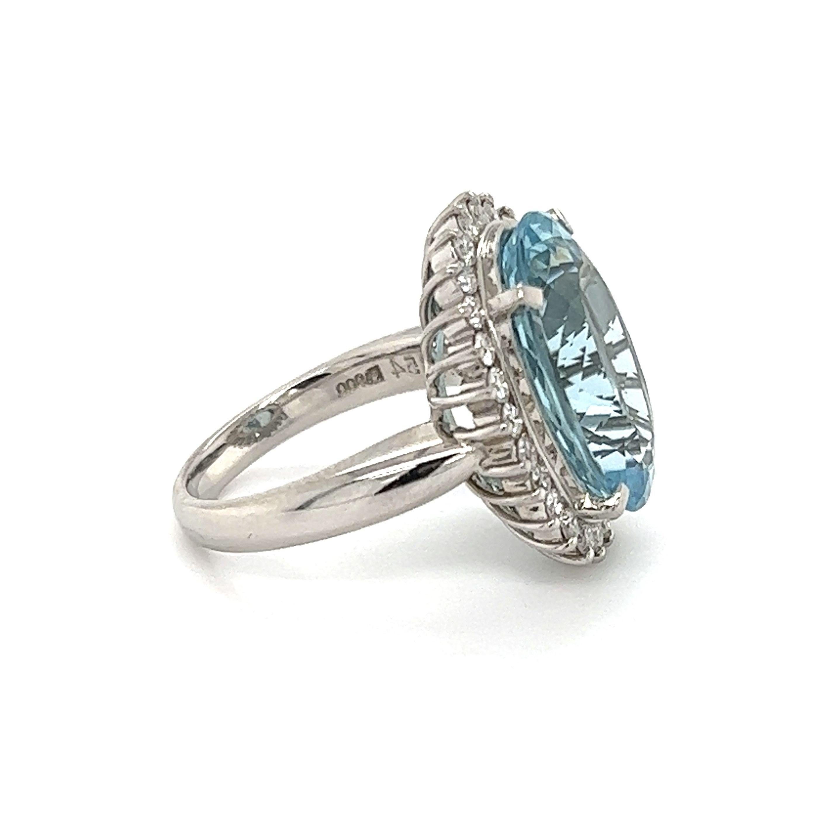 Simply Beautiful! Finely detailed Platinum Halo Ring, center securely nestled with an Oval Aquamarine, weighing approx. 9.25 Carats surrounded by Diamonds; approx. total weight of Diamonds 0.67 Carats. Approx. dimensions: 1.04” l x 0.82” w x 0. 84”