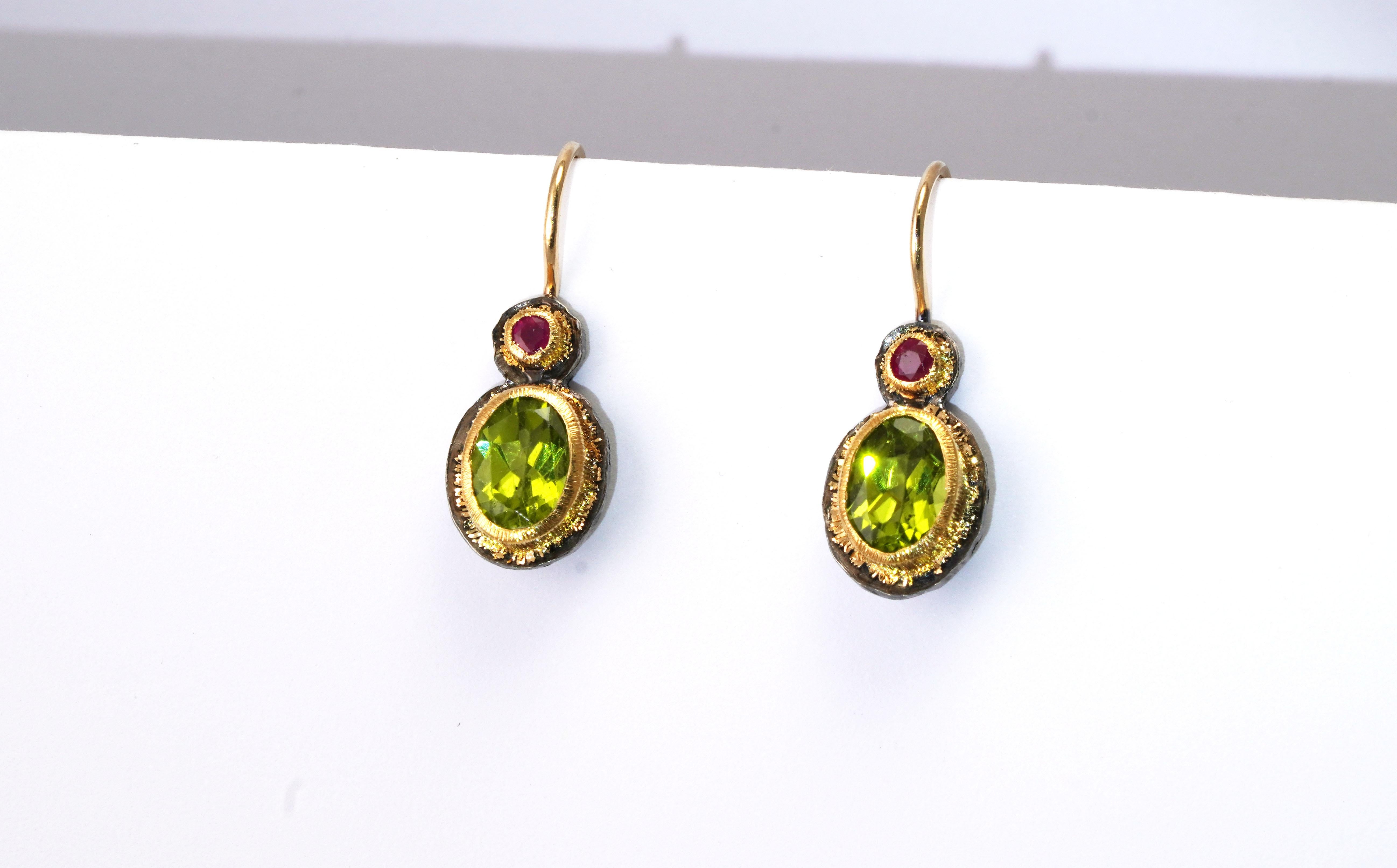 925 Oxidized Silver Earrings
Gold kt: 22 
Gold color: Yellow
Dimensions: 25 mm length
Total weight: 3.31 grams

Set with:
- Peridot
Cut: Mixed
Total weight: 2.90 carats (total)
Color: Green
- Ruby
Cut: Mixed
Total weight: 0.14 carat
Color: Red
