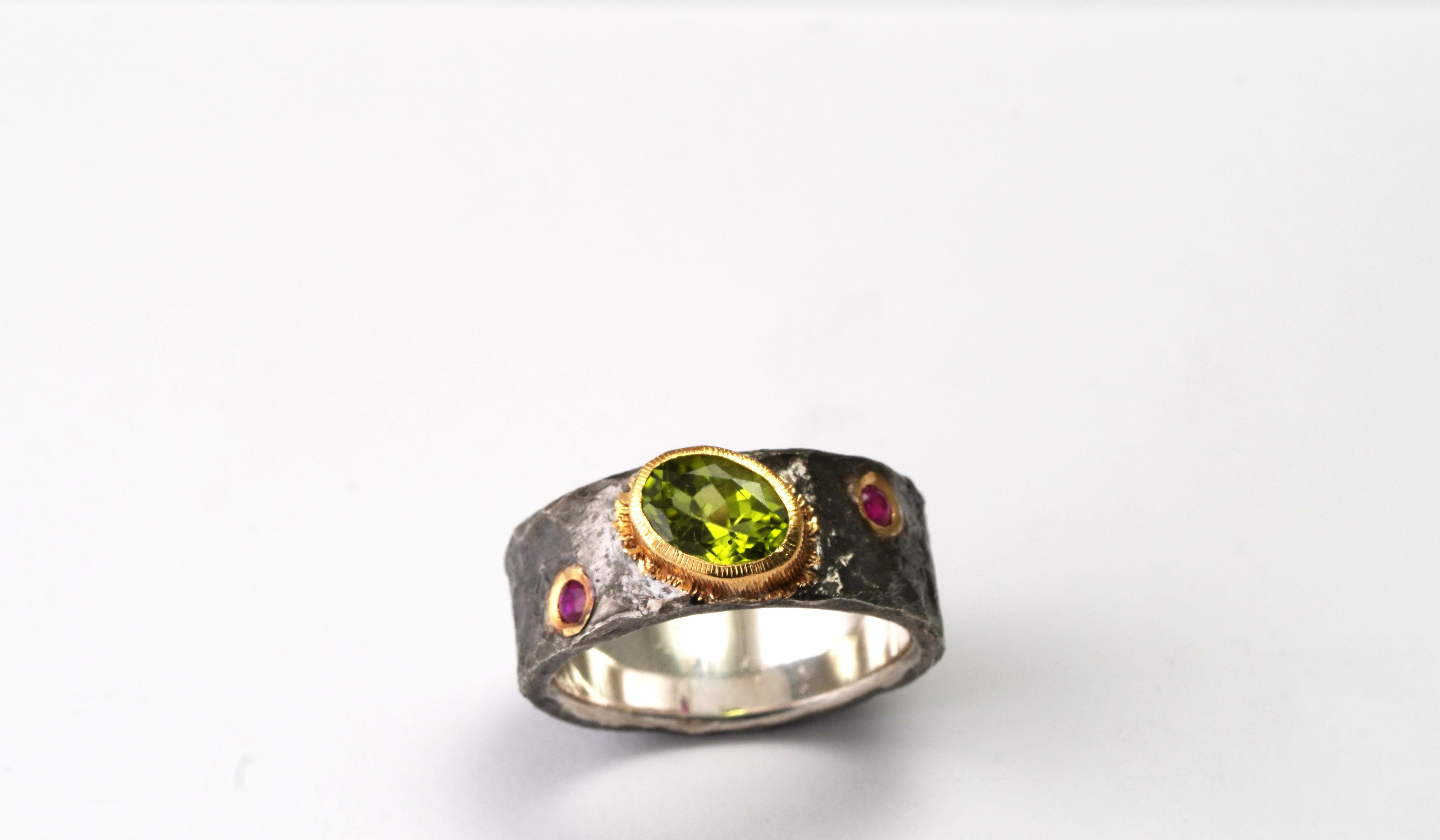 925 Oxidized Silver Ring
Gold kt: 22 
Gold color: Yellow
Ring size: 6 3/4 US
Total weight: 8.64 grams

Set with:
- Peridot
Cut: Mixed
Total weight: 1.45 carat
Color: Green
- Ruby
Cut: Mixed
Total weight: 0.10 carat
Color: Red
