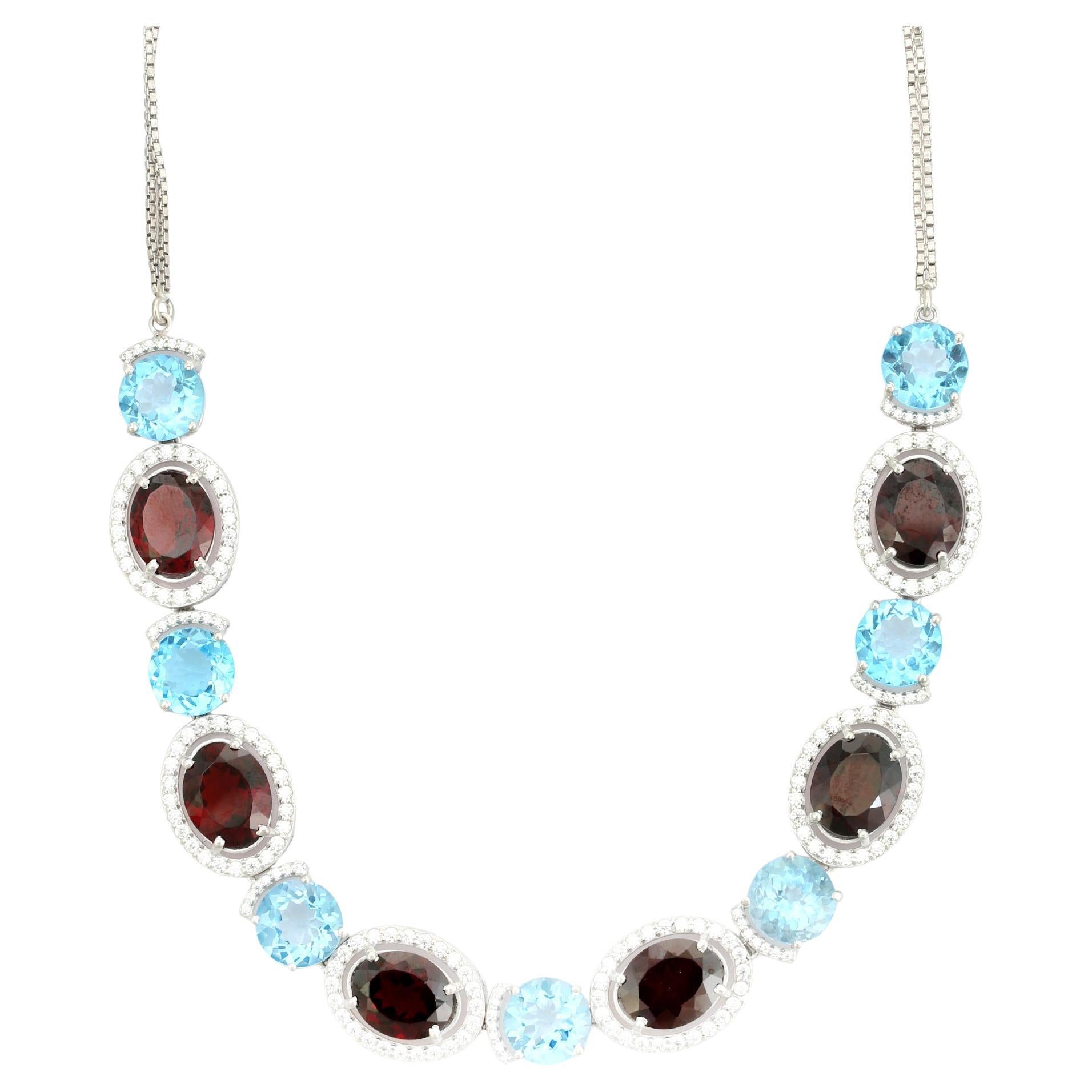 Collar de plata 925 con granate y topacio azul en dos tonos y halo de circonitas cúbicas en venta