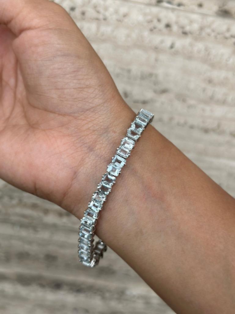 Exquisite Aquamarine Gemstone Tennis Bracelet for Her in sterling silver showcases endlessly sparkling natural aquamarine, weighing 23.1 carat. It measures 7.5 inches long in length. 
Aquamarine stimulate concentration and reduces stress. 
Designed