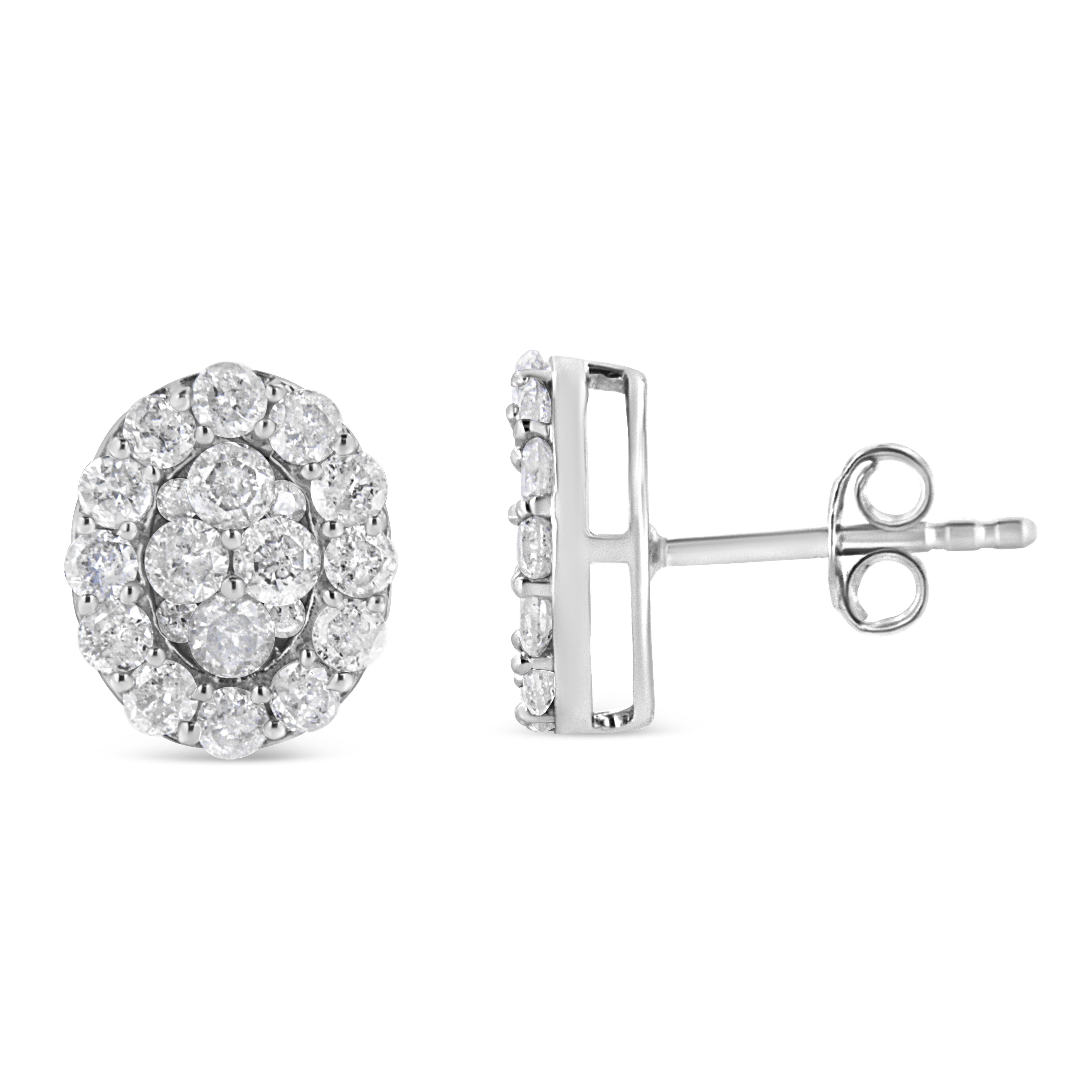 These glamorous earrings are set with a dazzling total diamond weight of 1 1/2 cttw. Designed in an ovular manner, these earrings are set with 40 round-cut diamonds in an elegant prong setting. The overlapping of the diamonds gives these earrings a