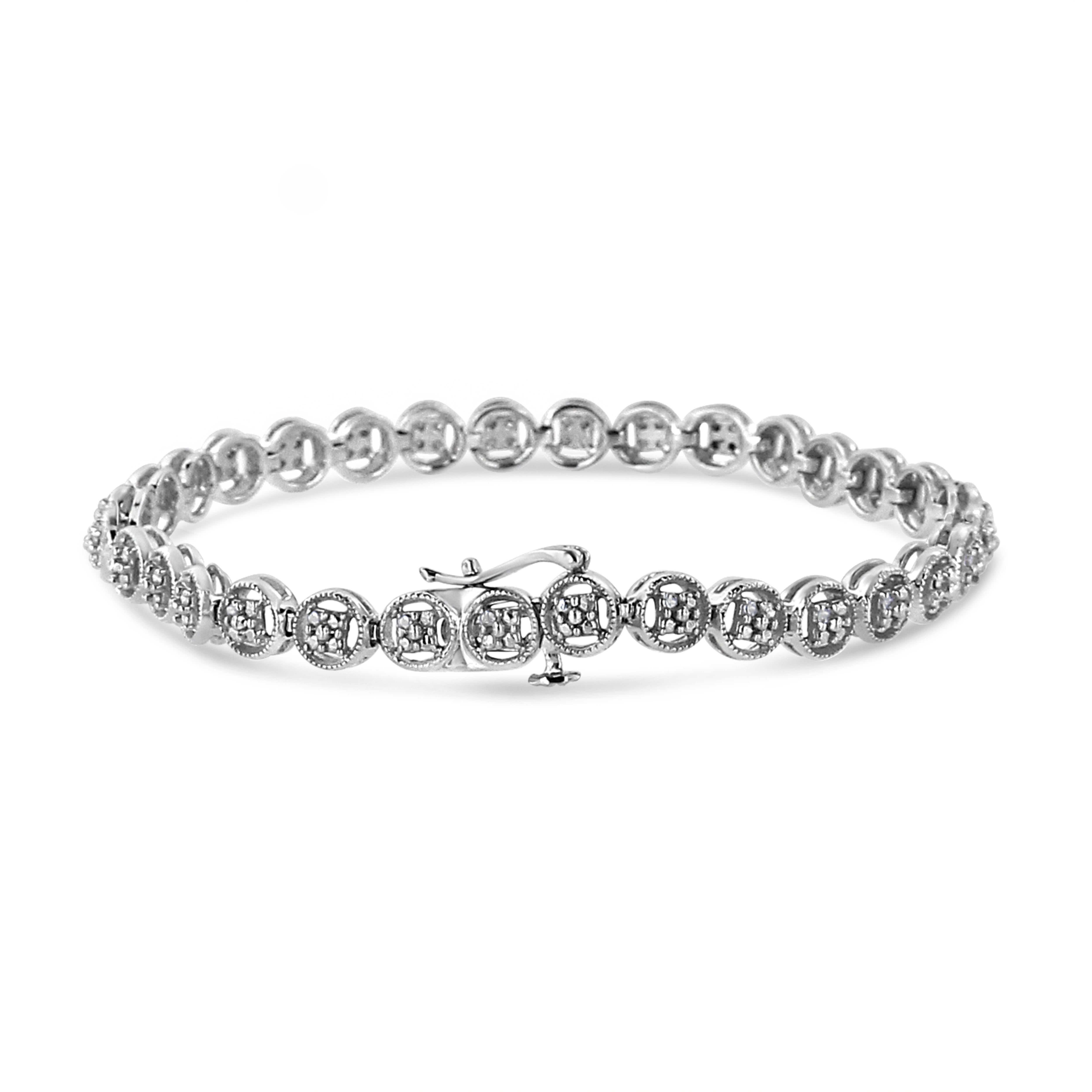 Elegant and timeless, this gorgeous .925 sterling silver tennis bracelet features 0.11 carat total weight of round, brilliant cut diamonds nestled in the center of open wheel shaped links decorated with studs that mimic the appearance of stones. The