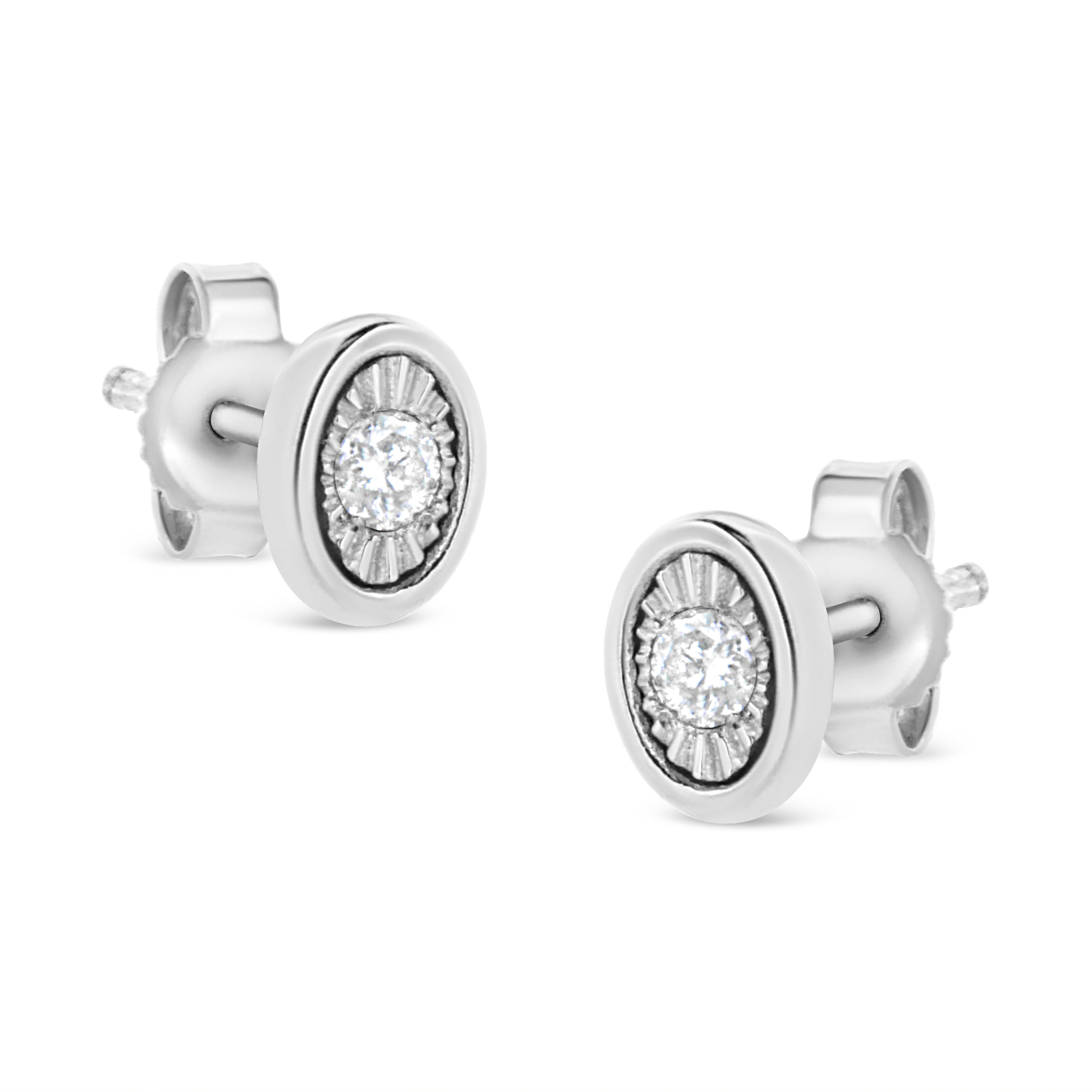 These oval shaped stud earrings are crafted in .925 sterling silver and feature 1/10ct TDW of diamonds. Each earring features a single sparkling round cut diamond in a miracle setting that adds to the earrings' sparkle. A polished silver halo