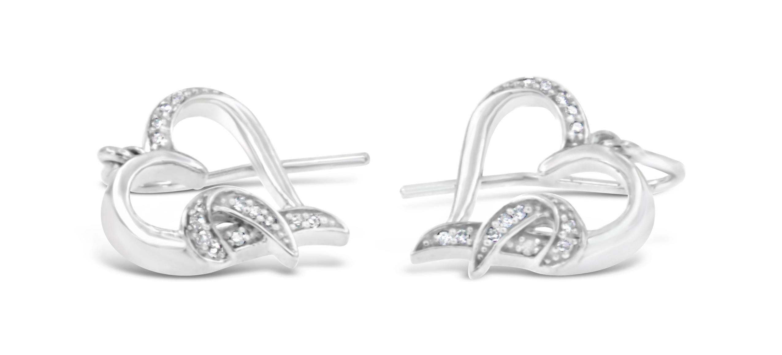 Representing the symbol of love, these heart shaped earrings are composed of high-quality sterling silver and buffed high to shine. The stunning jewel is embellished with sparkling round cut diamonds in a pave setting. The authentic earrings make a