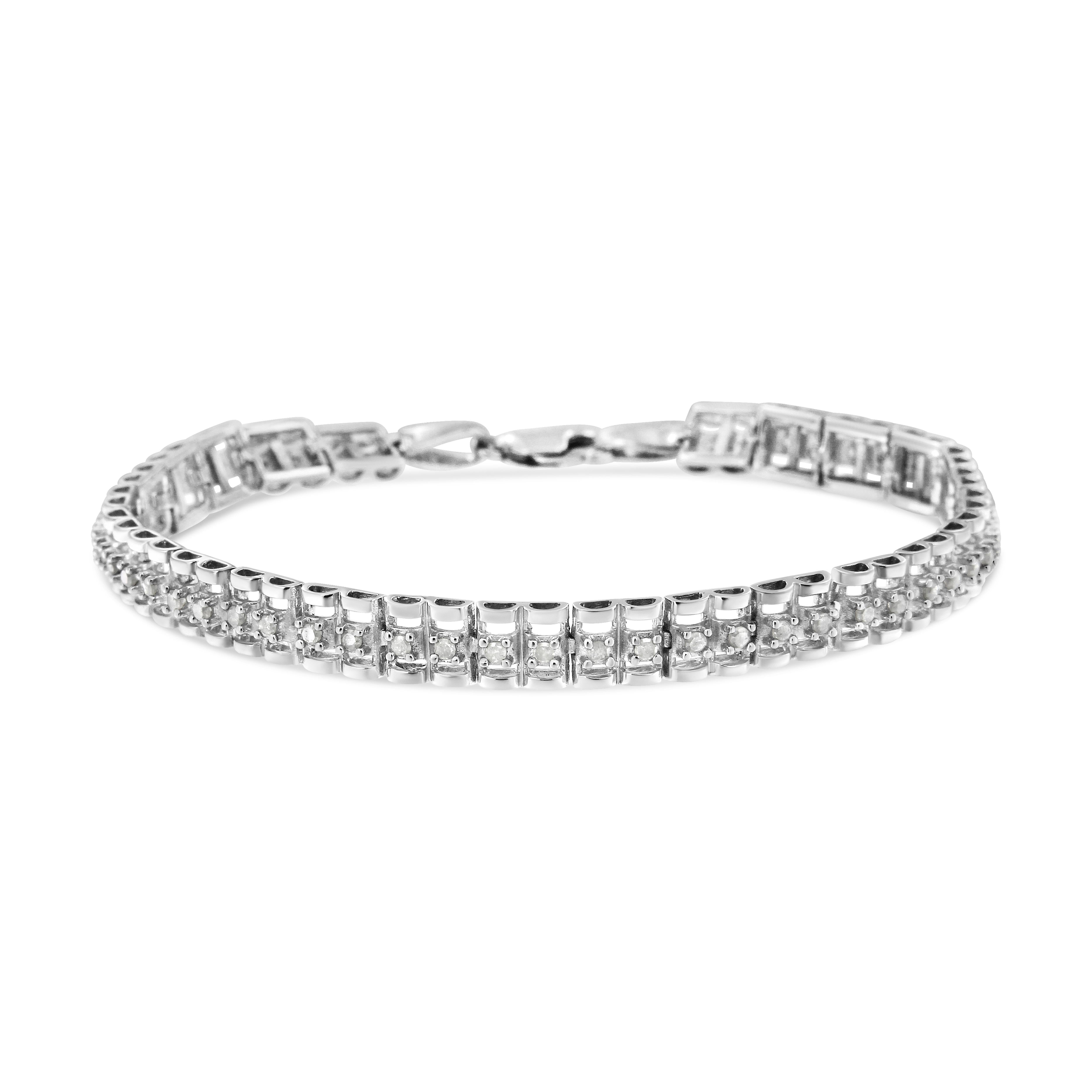 This gorgeous .925 sterling silver tennis bracelet features 0.50 carat total weight with 26 round, rose cut diamonds. The tennis bracelet has hinged links with two shapes surrounding two diamonds on each side. Rose-cut, promo quality diamonds are