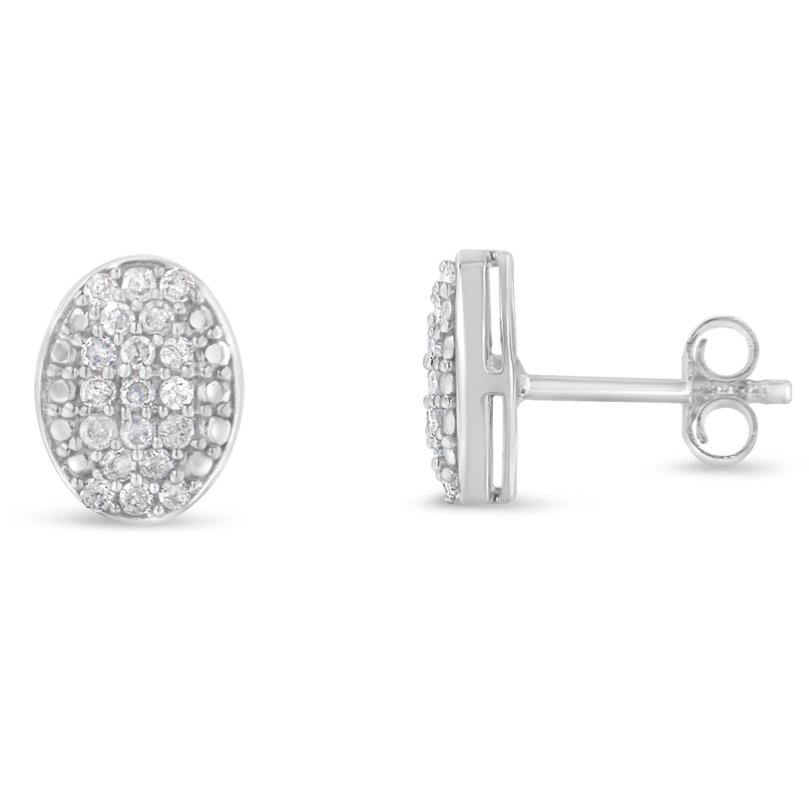 These oval stud cluster earrings are fashioned in cool sterling silver and feature 1/2ct TDW of glittering, promo quality, round cut diamonds. A push back mechanism gives the earrings a secure fit.  Promo quality diamonds are on the lowest of