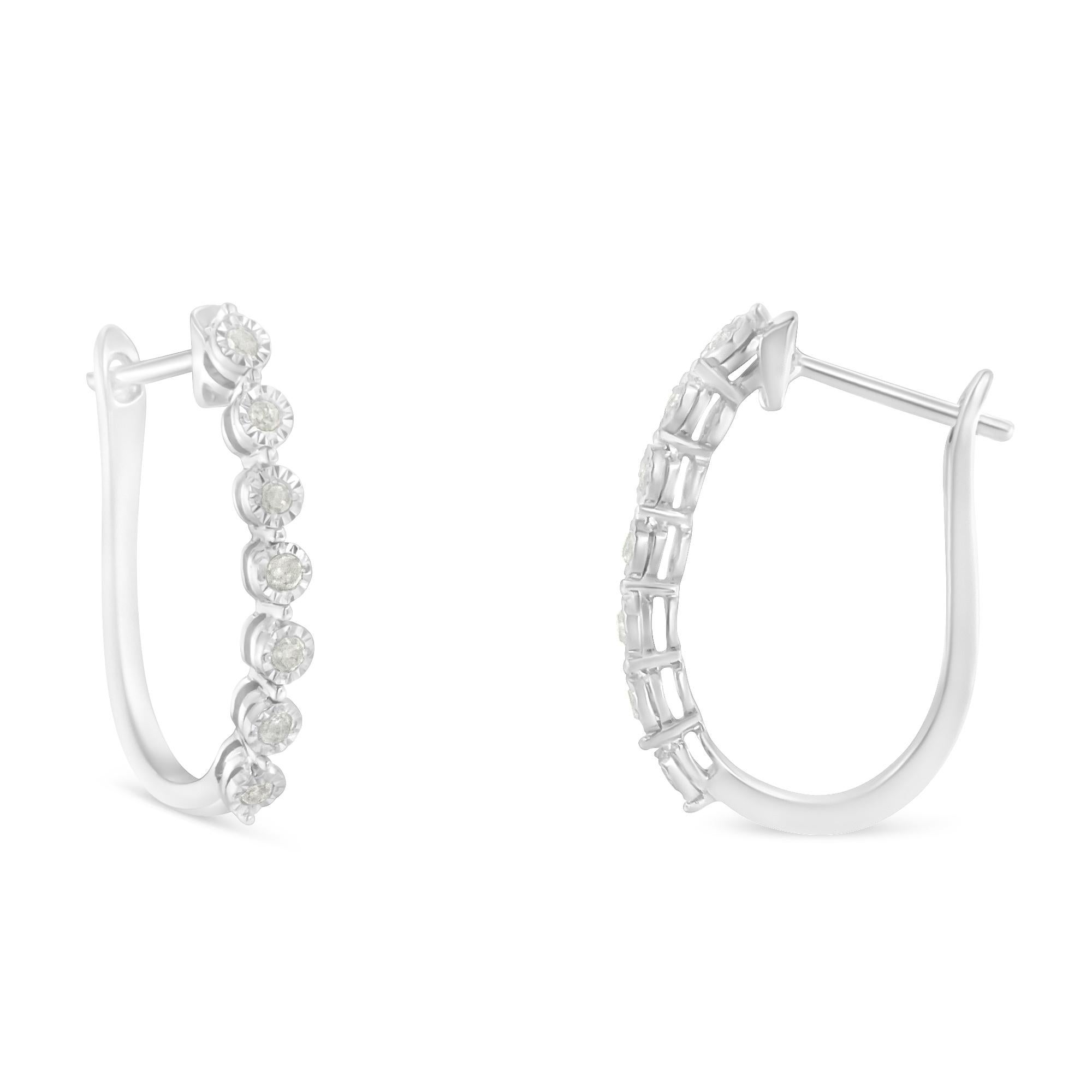 Elegant and timeless, these gorgeous sterling silver diamond hoop earrings feature 0.50 carat total weight of round diamonds. Each U shaped earring is set with seven stones in illusion settings. The fourteen round diamonds are each set in the center