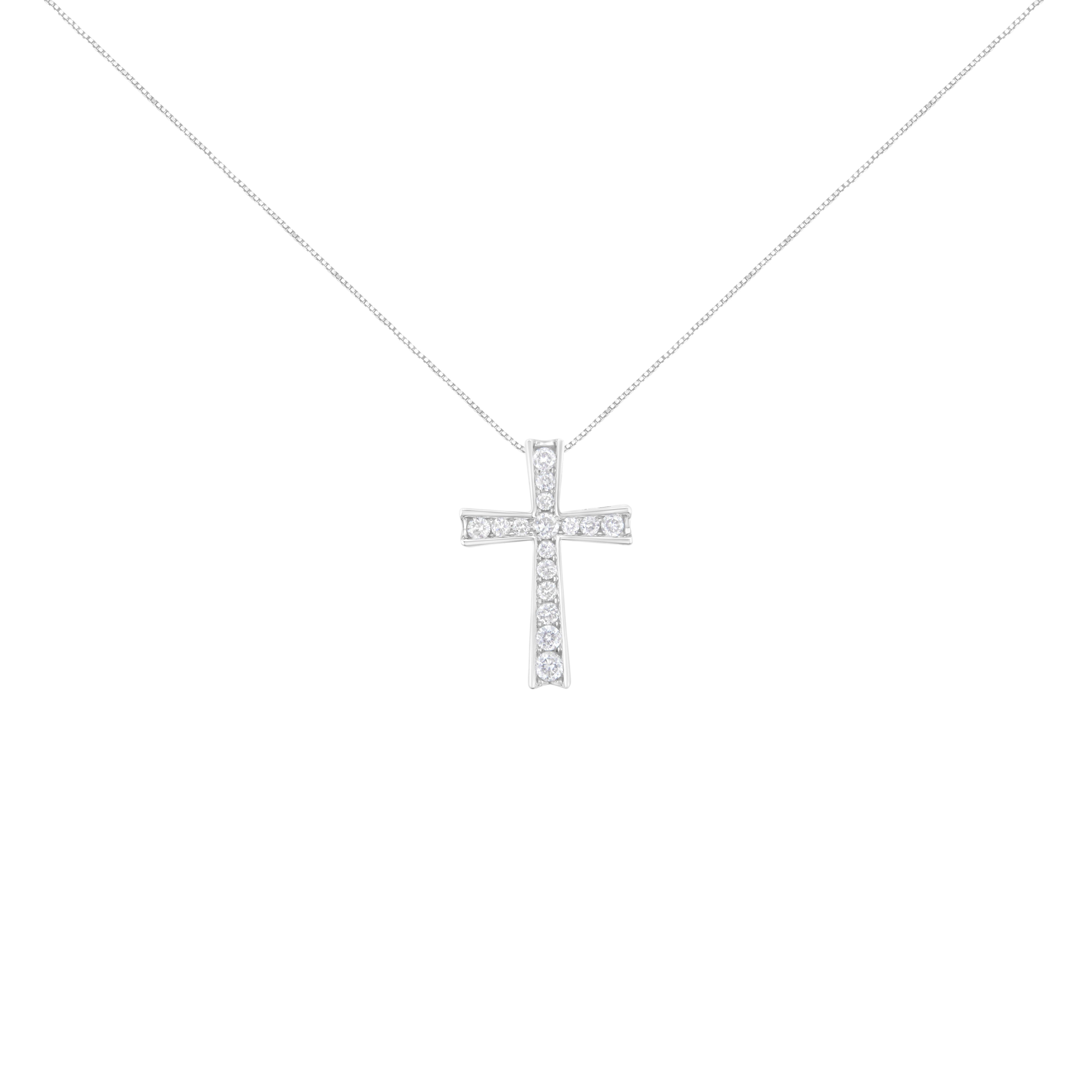 Seventeen dazzling prong set round cut diamonds stud this beautiful cross pendant. This symbol of faith is crafted in sterling silver and features 1/2ct TDW in diamonds. A box chain that secures with a spring ring clasp is the perfect complement to