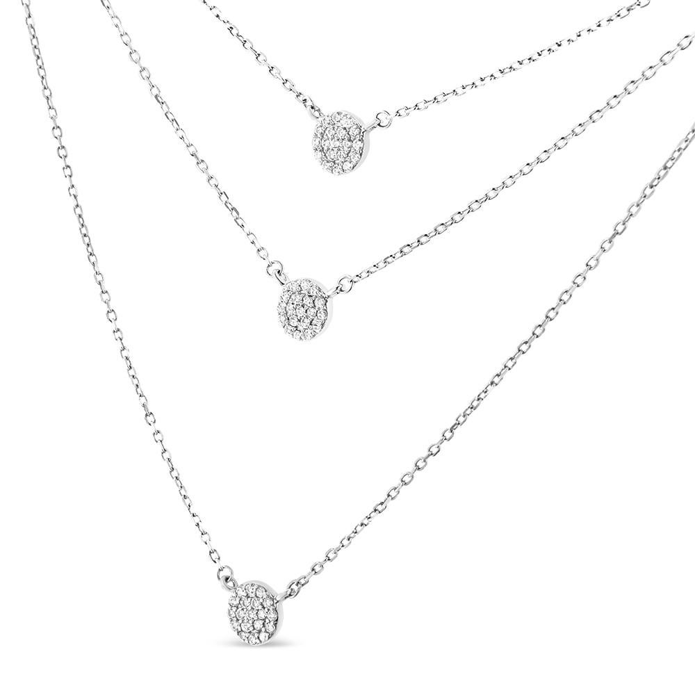 Three chains provide a pre-layered look for your day or evening attire when you slip on the sparkling splendor of this tri pendant necklace. Three circular medallion pendants suspend from modern rope chains, comprised of clusters of round, prong-set