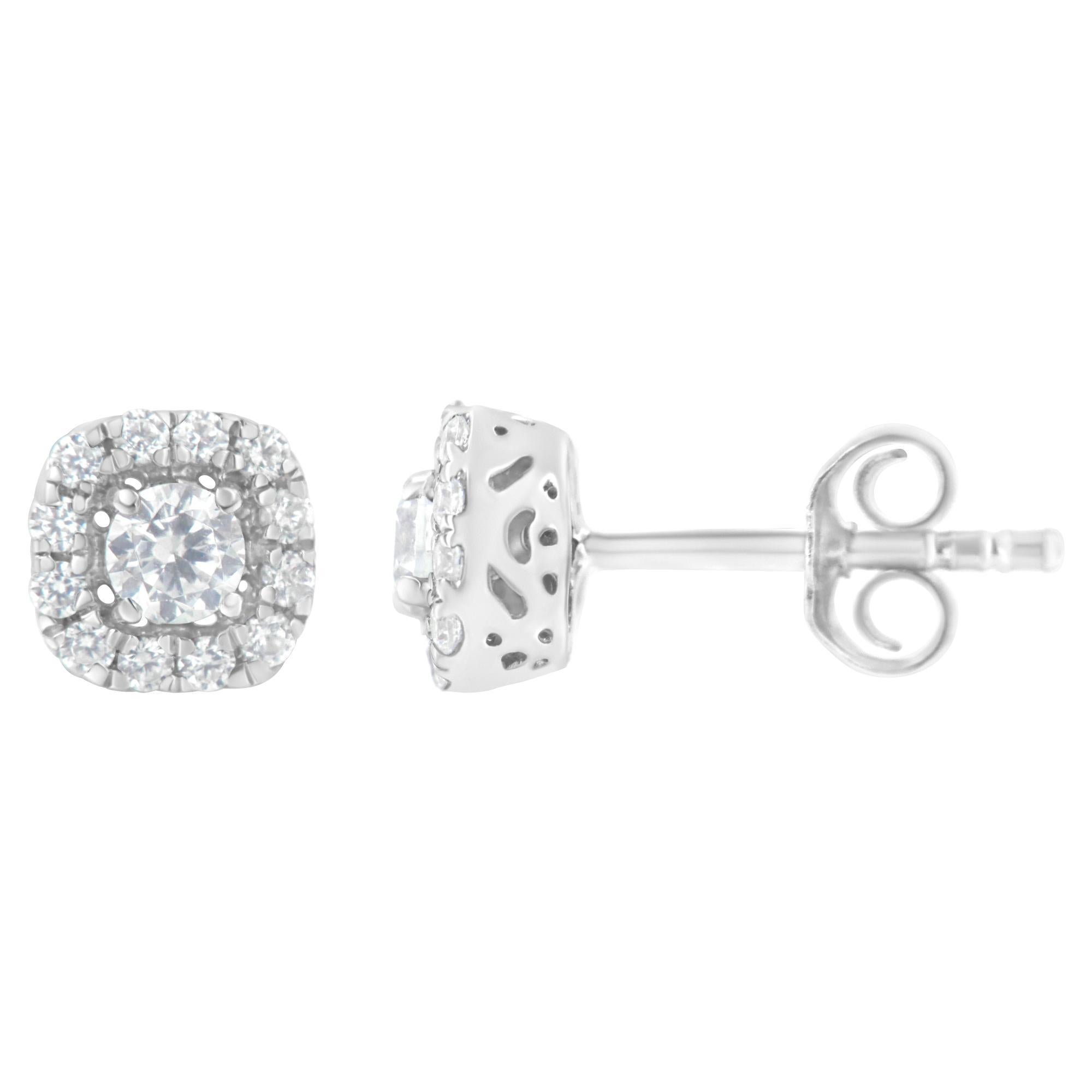 Un éblouissant diamant rond est la pièce maîtresse de ces boucles d'oreilles. Un halo de diamants ronds plus petits entoure la pierre centrale en forme de coussin. 1/2ct TDW de diamants sont présentés dans ces boucles d'oreilles en argent sterling