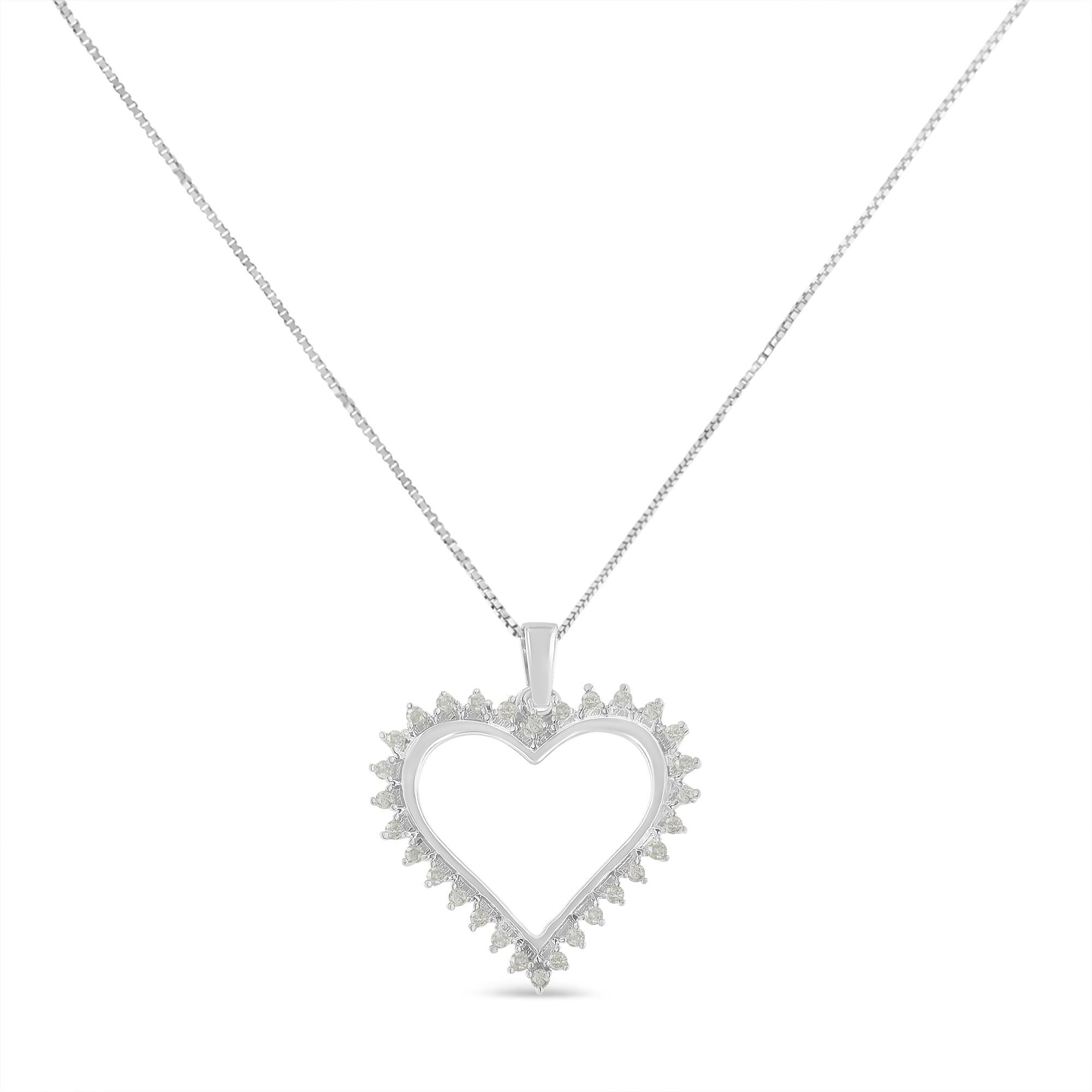A shimmering halo of prong set, round cut diamonds sit around a lovely open heart pendant. 1/4ct TDW of diamonds sparkle in this sterling silver design. The pendant hangs from a box chain that secures with a spring ring clasp.

