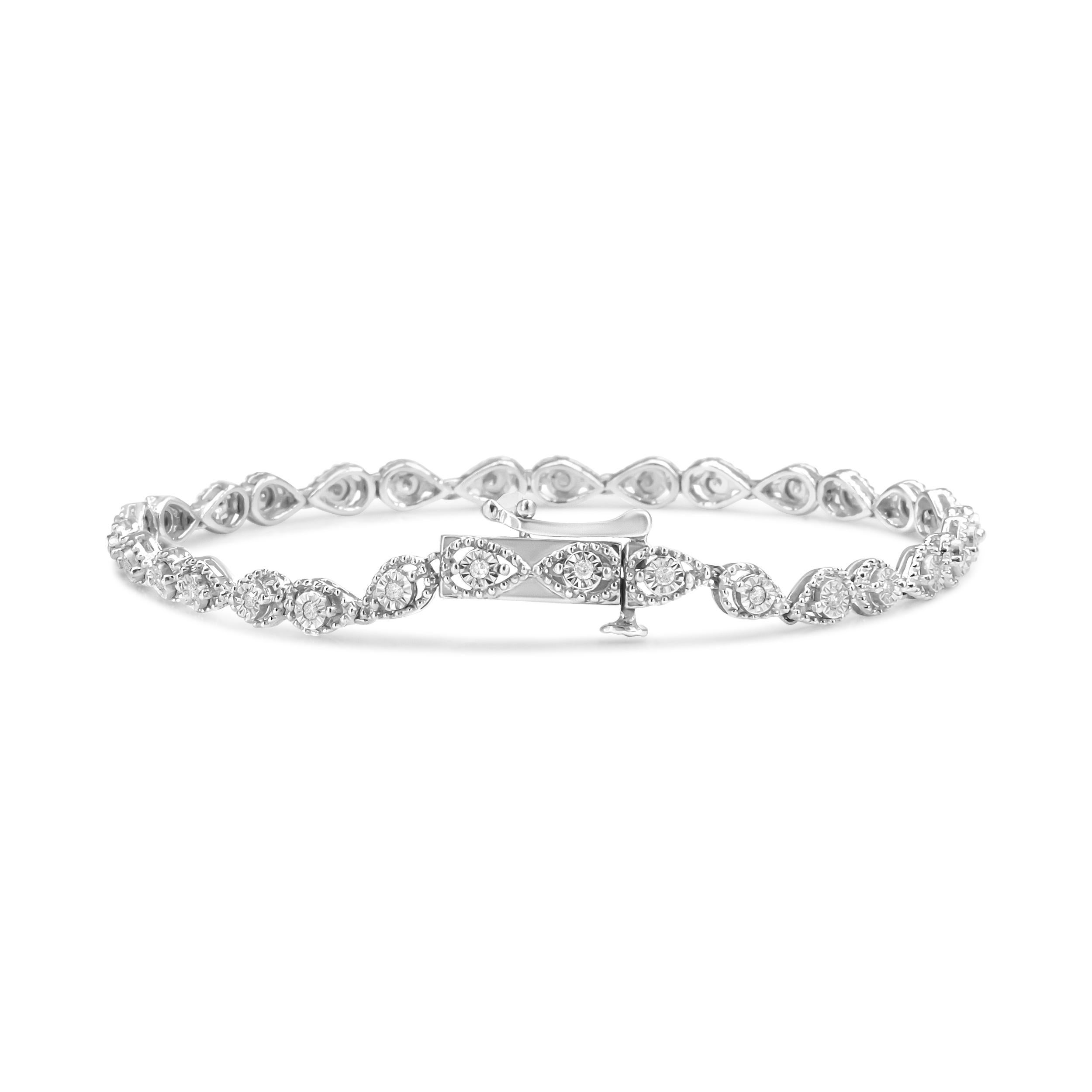 This beaded marquise-shaped link bracelet exudes an irresistible retro allure. Crafted in .925 Sterling Silver, the feminine piece is adorned with 30 natural round diamonds that total up to 1/4 cttw, secured in a miracle setting. Measuring 7.25