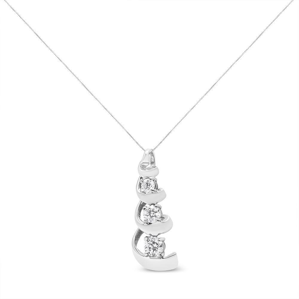 Enjoy the sparkle of this elegant diamond pendant. Created in the swirl shape and fashioned from lustrous sterling silver, the necklace is polished to radiant. Featuring shimmering three round cut diamonds, the arrangement of every diamond is made