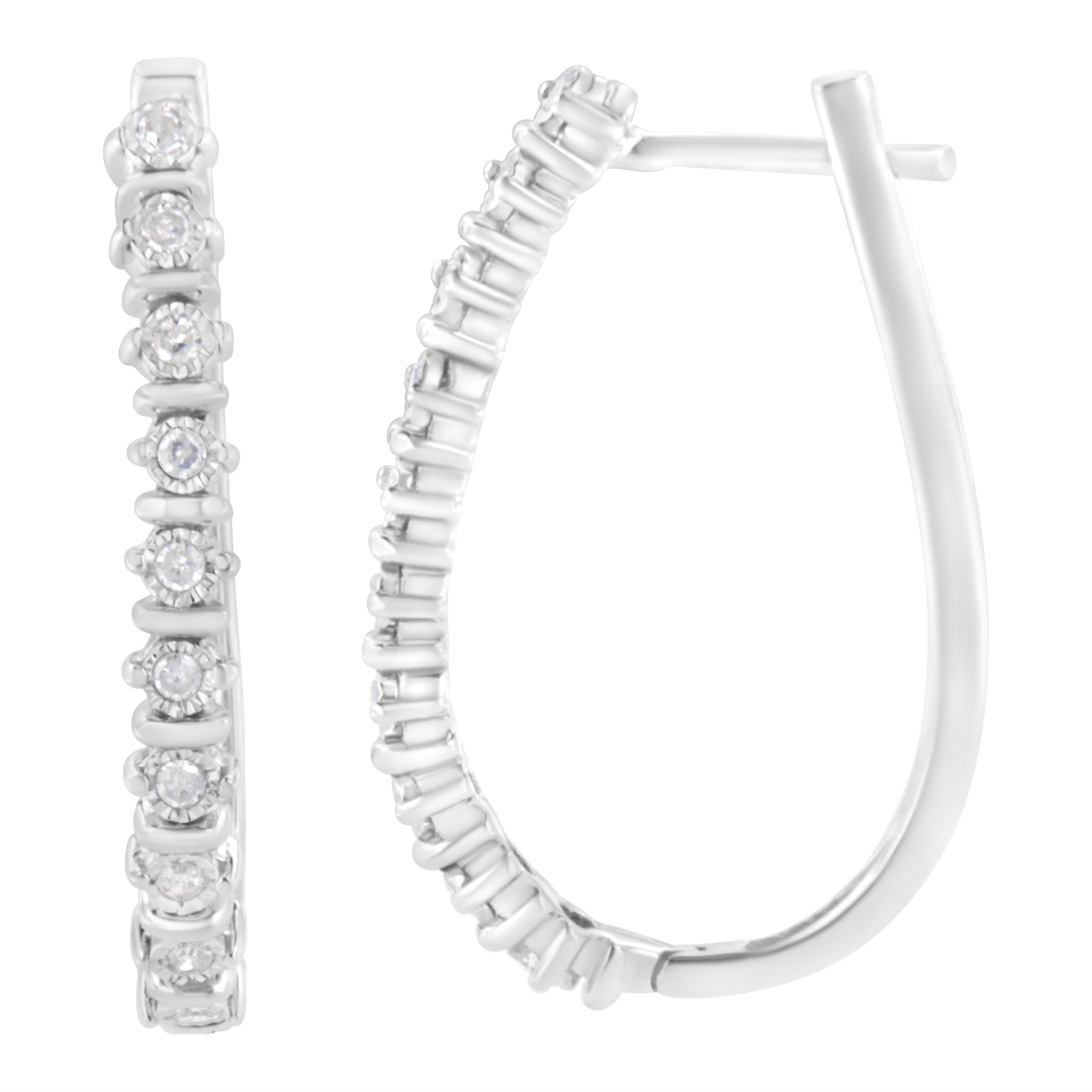 Crafted in cool sterling silver, these stunning hoop earrings feature 1/4ct TDW of diamonds. Each hoop features glittering miracle set diamonds separated by polished silver ribbons outlining the front outside edge. A classic design that won't go out