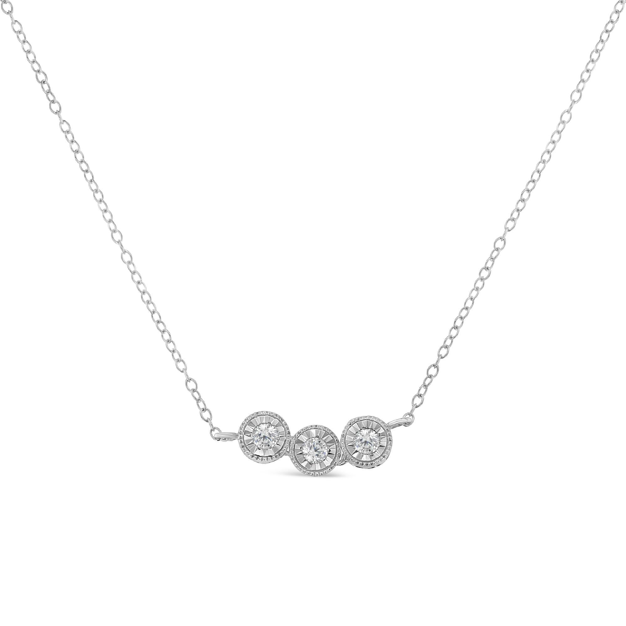 A diamond necklace that features three round diamonds set along a thin, delicate chain. The charming design has milgrain beading giving it a vintage touch. It is crafted in cool sterling silver and has a total diamond weight of 1/4 carats.


