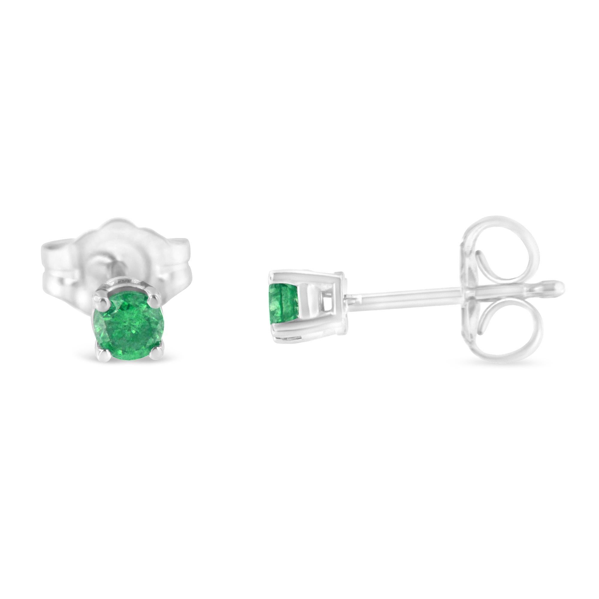 A pair of treated green diamond and sterling silver stud earrings. Each earring features a round diamond set into a .925 quality sterling silver prong setting. The total diamond weight is .25 carats. They are finished with a push back