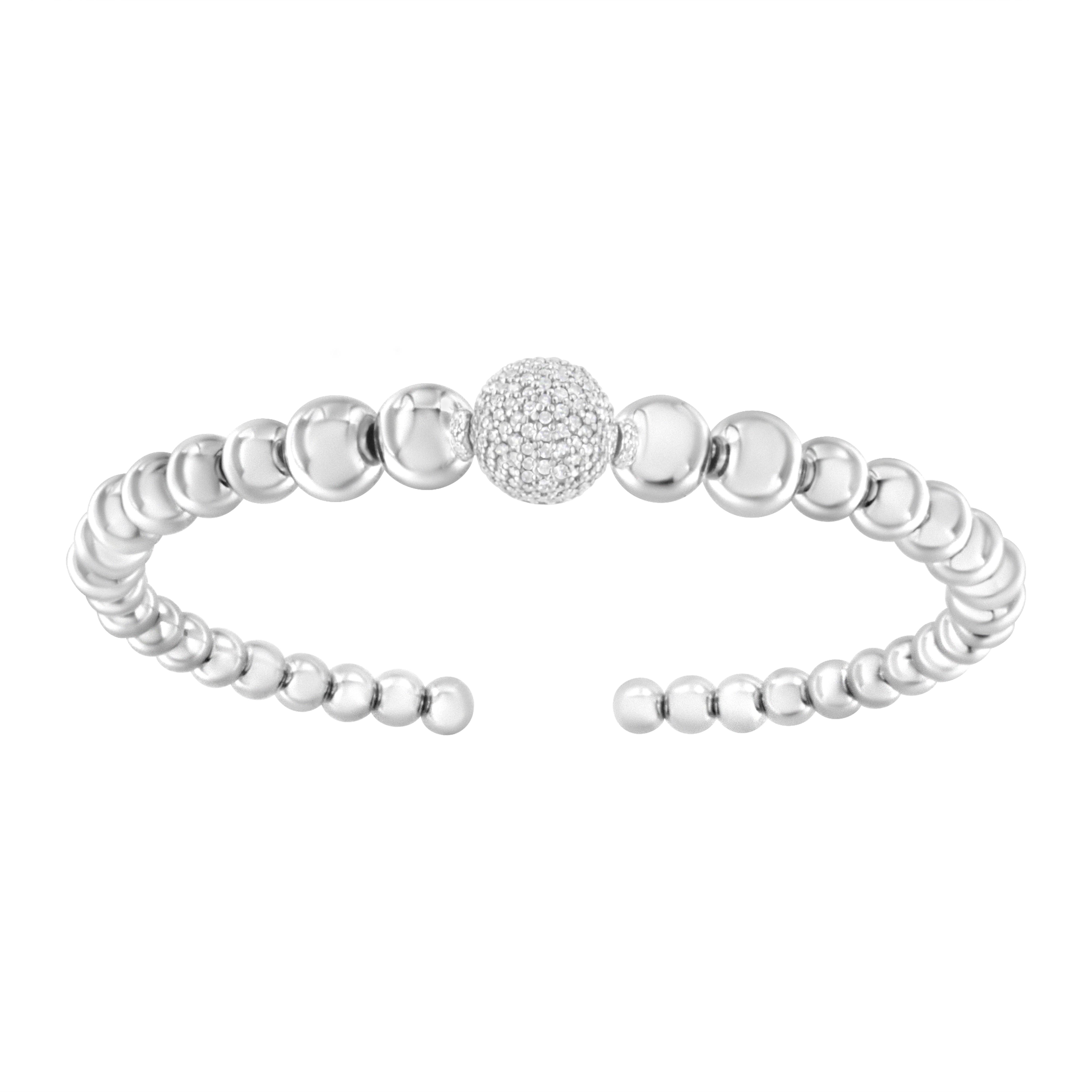 Simple yet elegant, this bangle cuff bracelet is a great anytime look. Strands of sleek sterling silver come together to form round ball links.  Loops of diamond accented bands alternate between each ball with shimmering diamond accents that add a