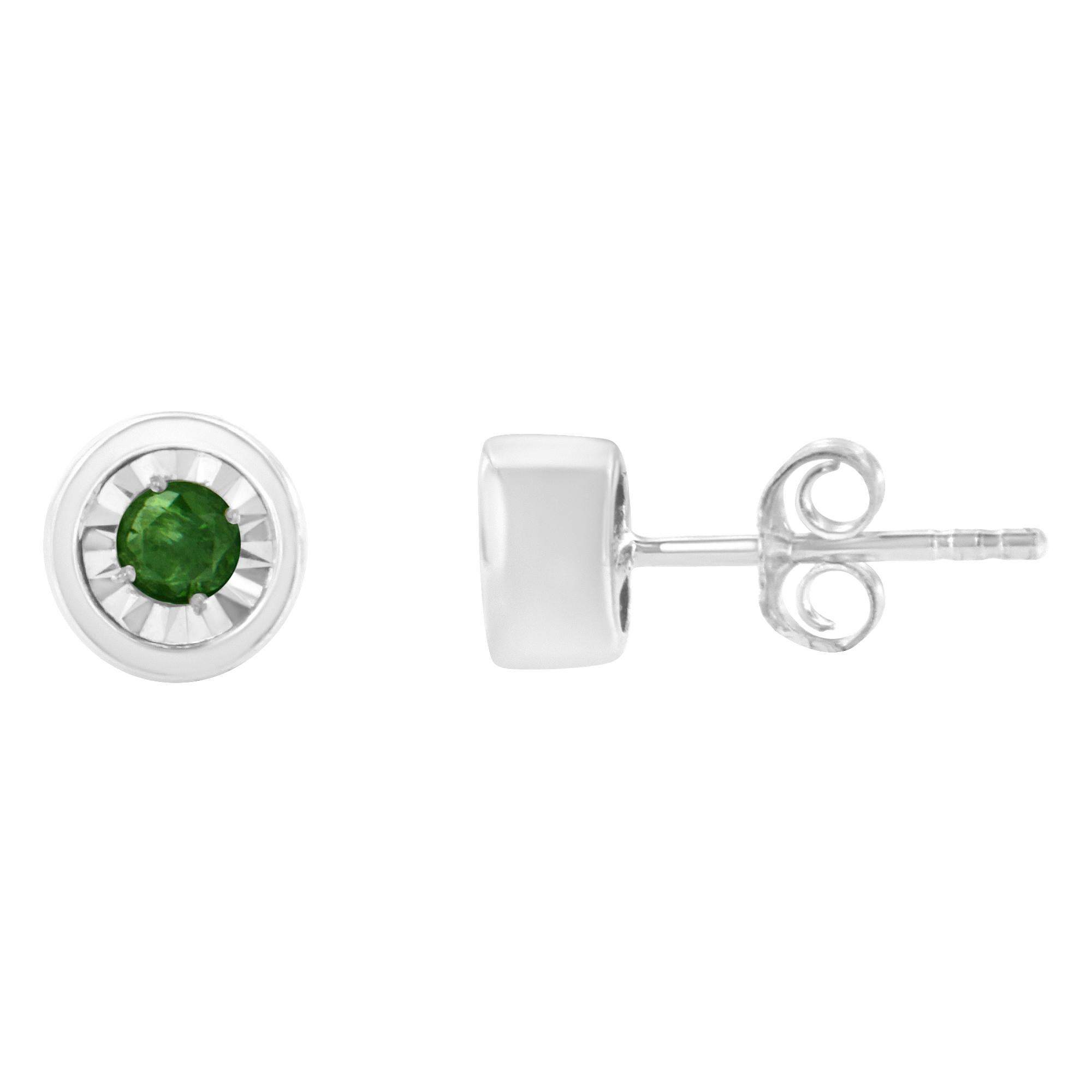 This modern pair of diamond studs features color treated green diamonds in a bezel setting. The sleek design is crafted in a cool sterling silver making them the perfect choice to add a touch of color to everyday wear. The total diamond weight is