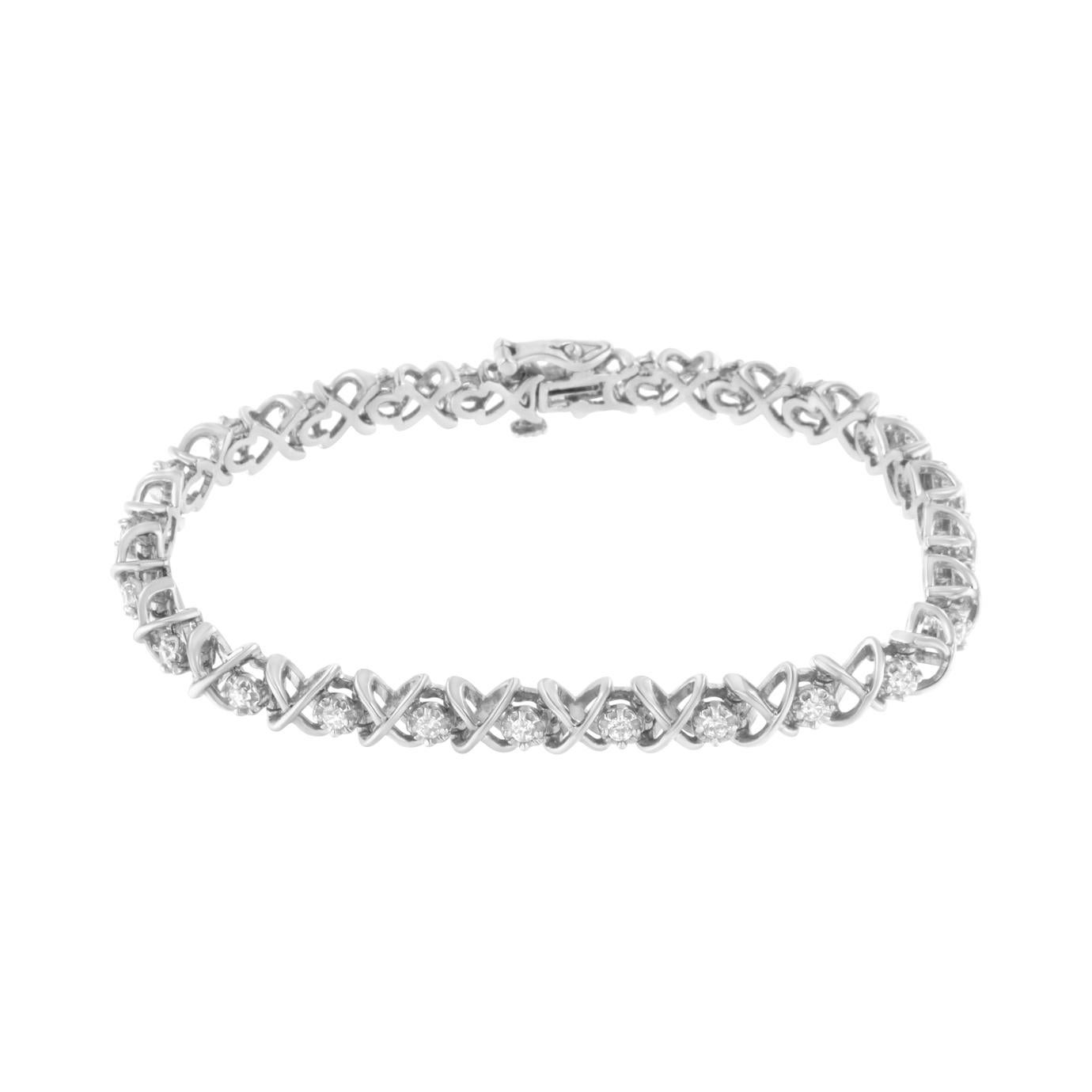 Crafted in polished sterling silver, this link bracelet features 1ct TDW of diamonds. Cool silver X shaped links alternate with prong set round cut diamonds to create this dazzling design. A box with clasp keeps the bracelet secure.

'Video