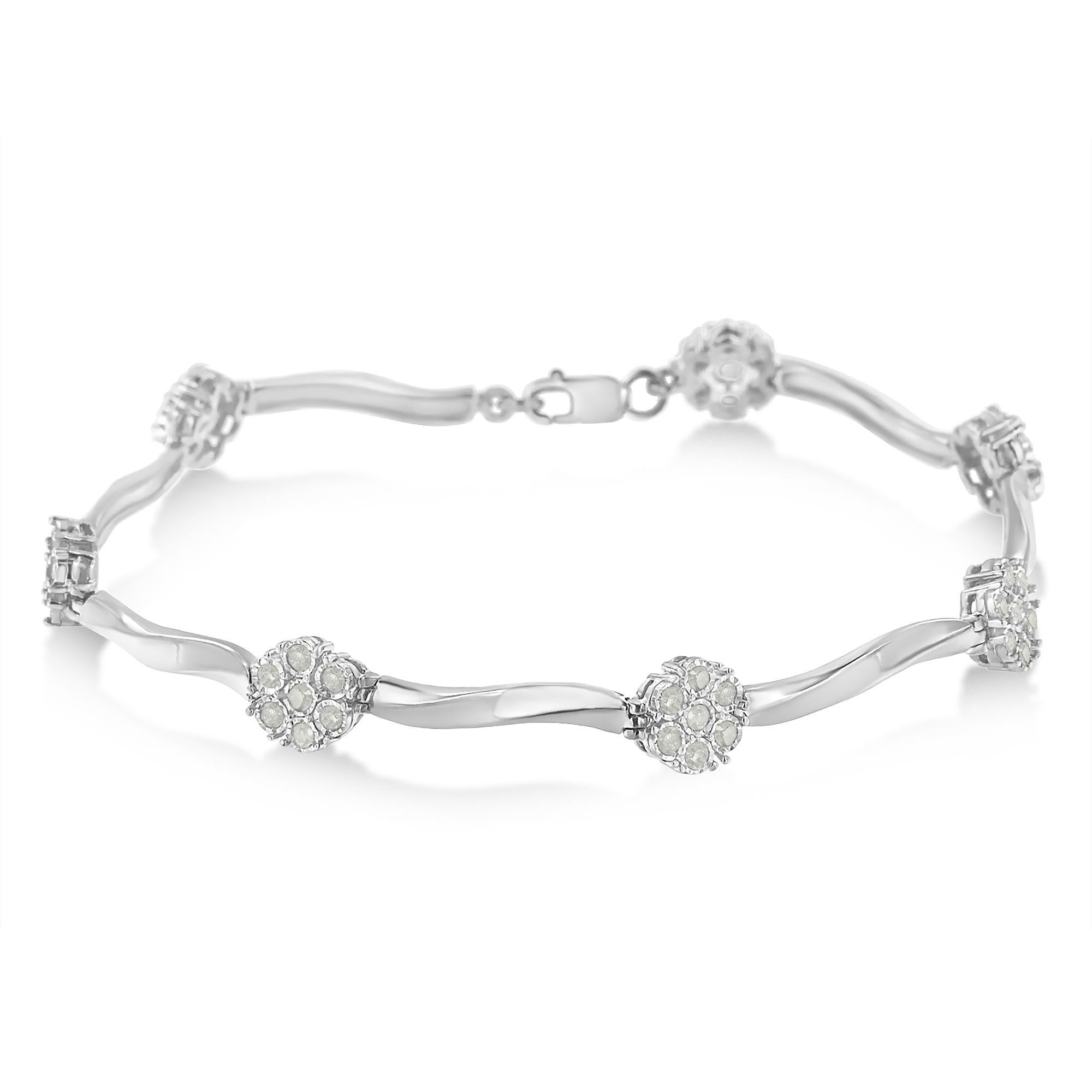 Elegant and timeless, this gorgeous sterling silver floral link bracelet features 1.0 carat total weight of round cut diamonds. The tennis bracelet features round, flower shaped cluster links along with an elongated S wave  link. The round links are