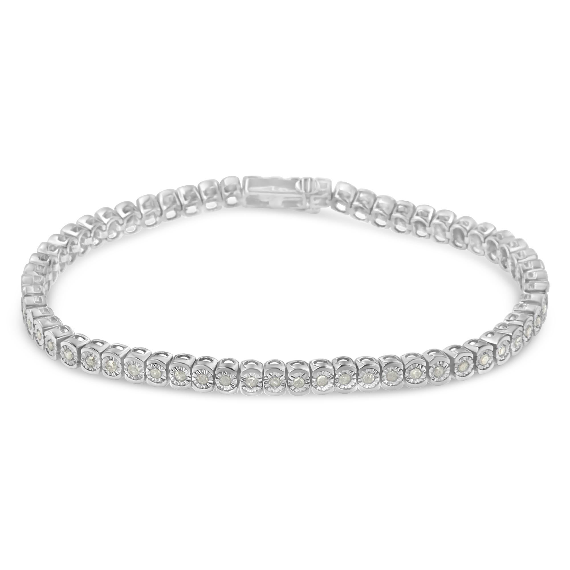 Sixty seven individual, miracle set diamonds link together to create this gorgeous tennis bracelet. Crafted in sterling silver, this classic design showcases 1ct TDW of sparkling round cut diamonds. The bracelet finishes of with a secure box clasp.