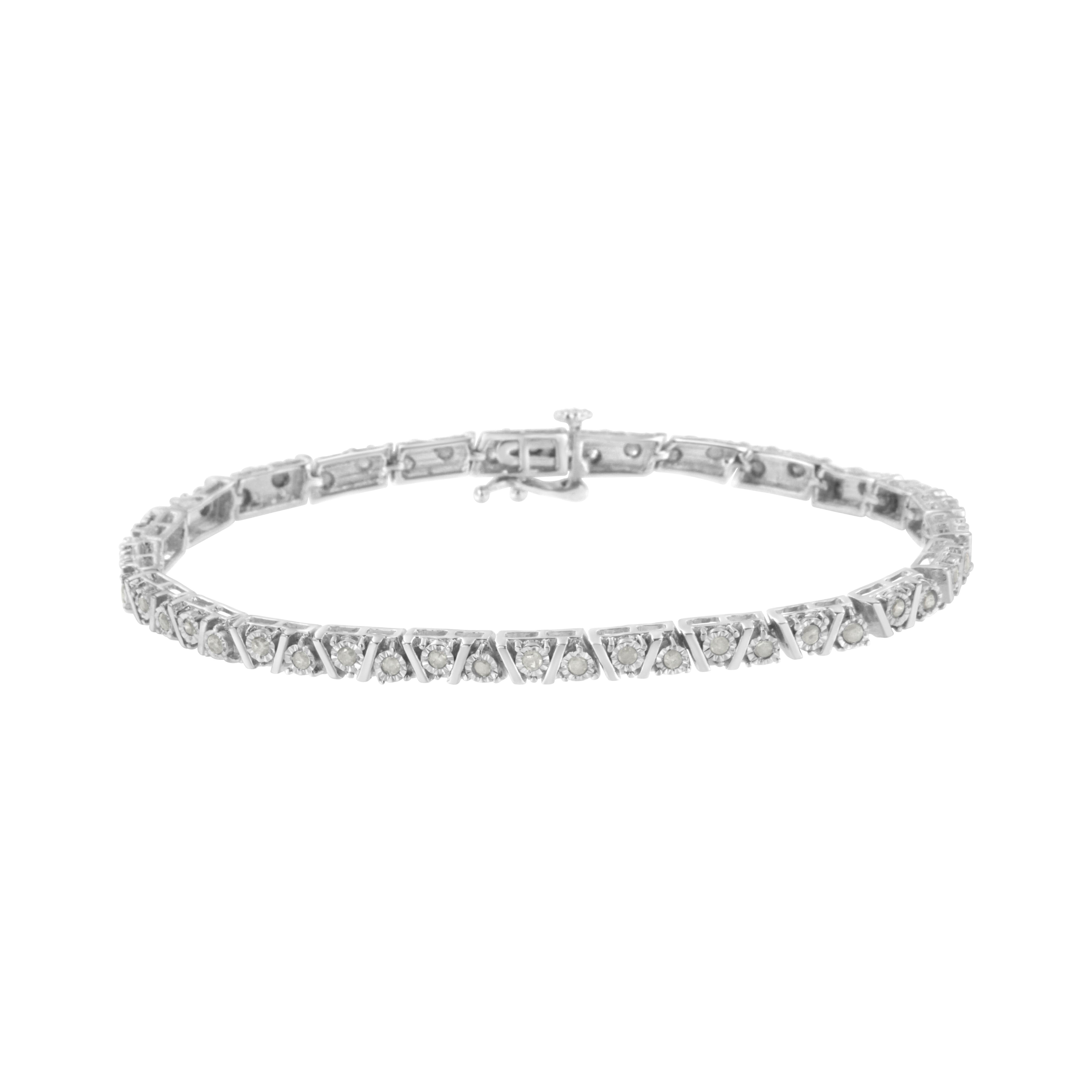 This lovely sterling silver bracelet shines with 1 carat TDW of diamonds and secures with a box with clasp. Sterling silver ribbons create a zigzag pattern along the length of the bracelet. Set in between the spaces created by the ribbons, miracle