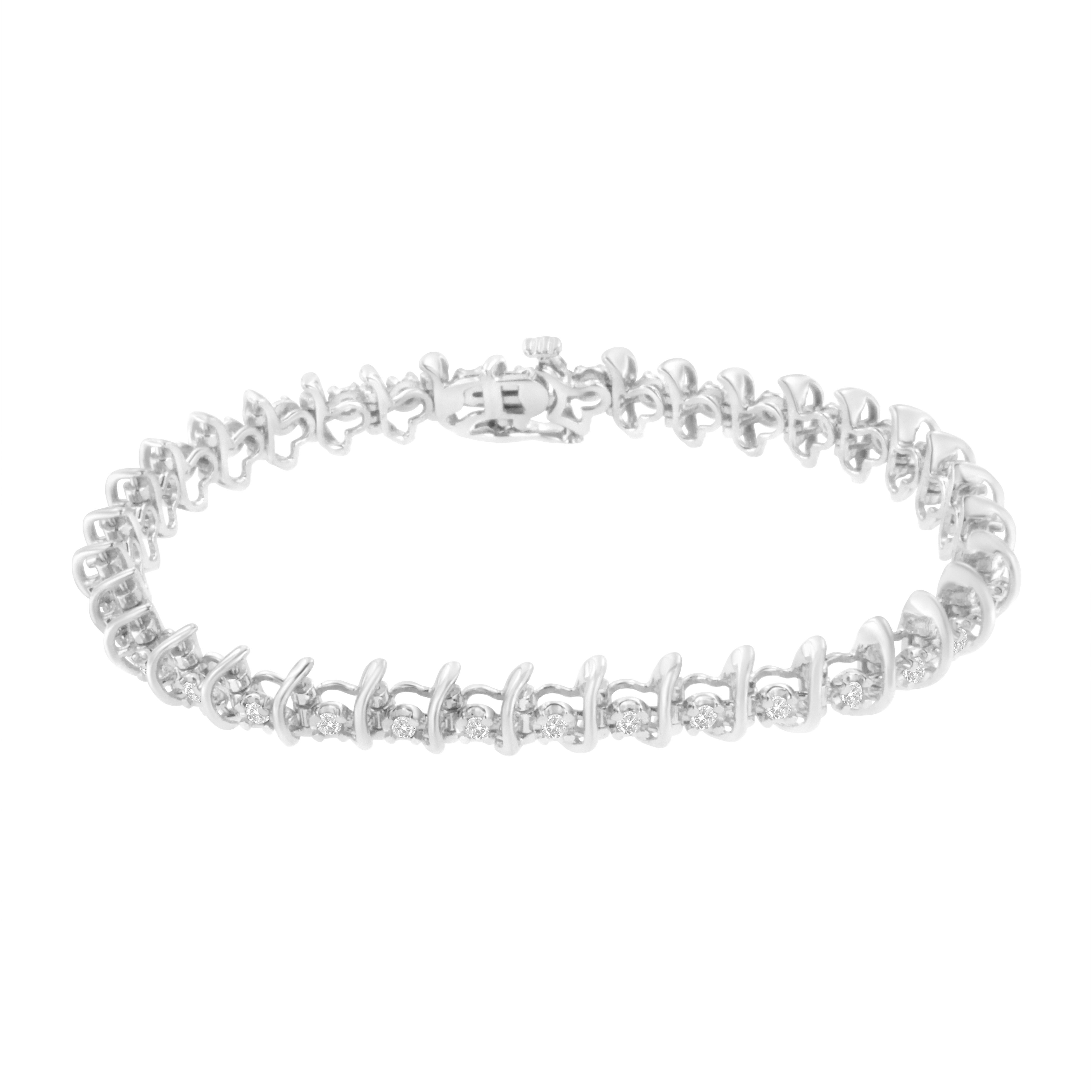 This stunning sterling silver link bracelet features round cut diamonds that glitter along the length of the bracelet. The 1 carat TDW of prong set diamonds alternate with soft waving ribbons of cool sterling silver. The bracelet secures with a box