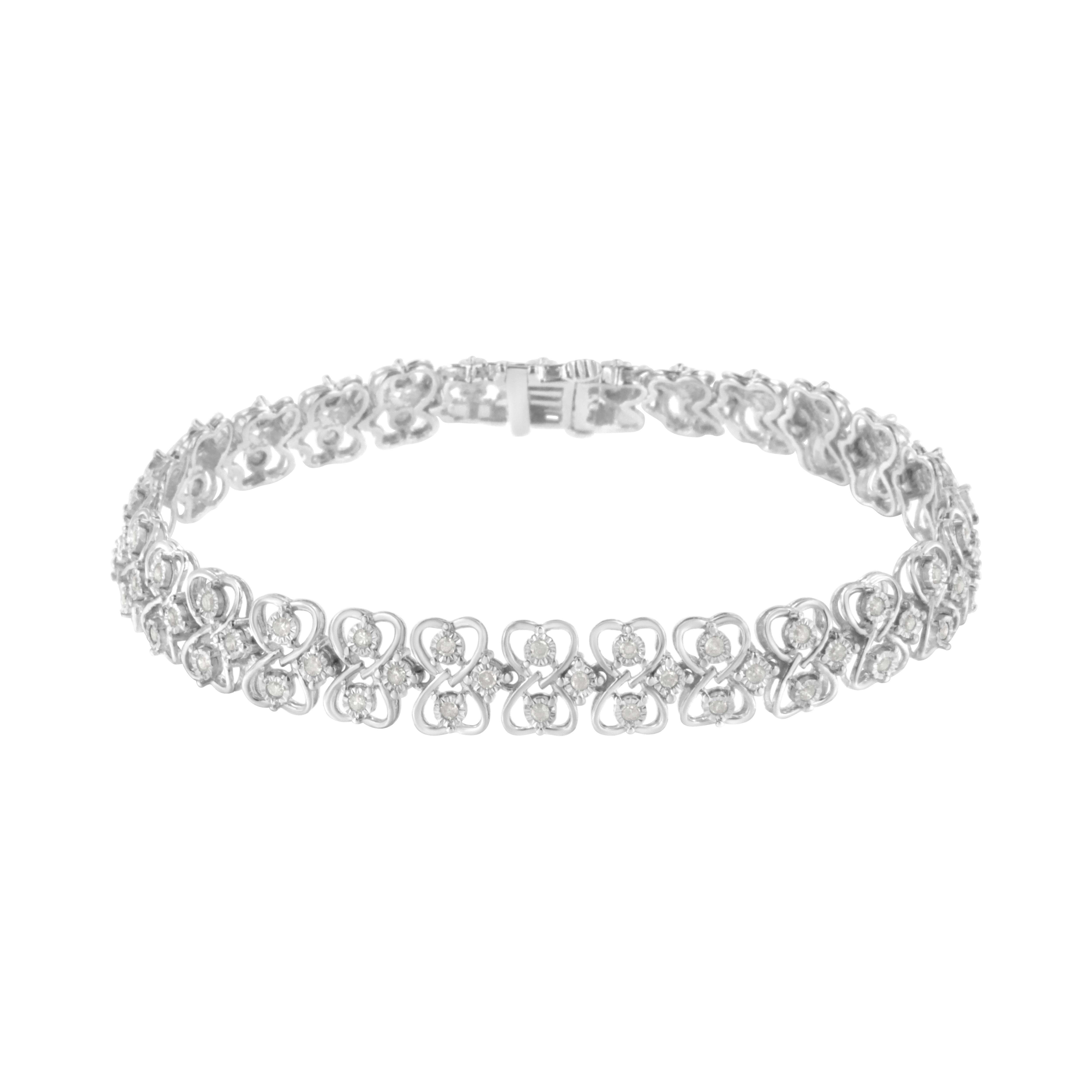 This lovely sterling silver link bracelet will make you stand out with 1 ct TDW of diamonds. Two heart cut outs sit opposite each other and create a ribbon like link that hold within two miracle set, round cut diamonds. Additional sparkling round