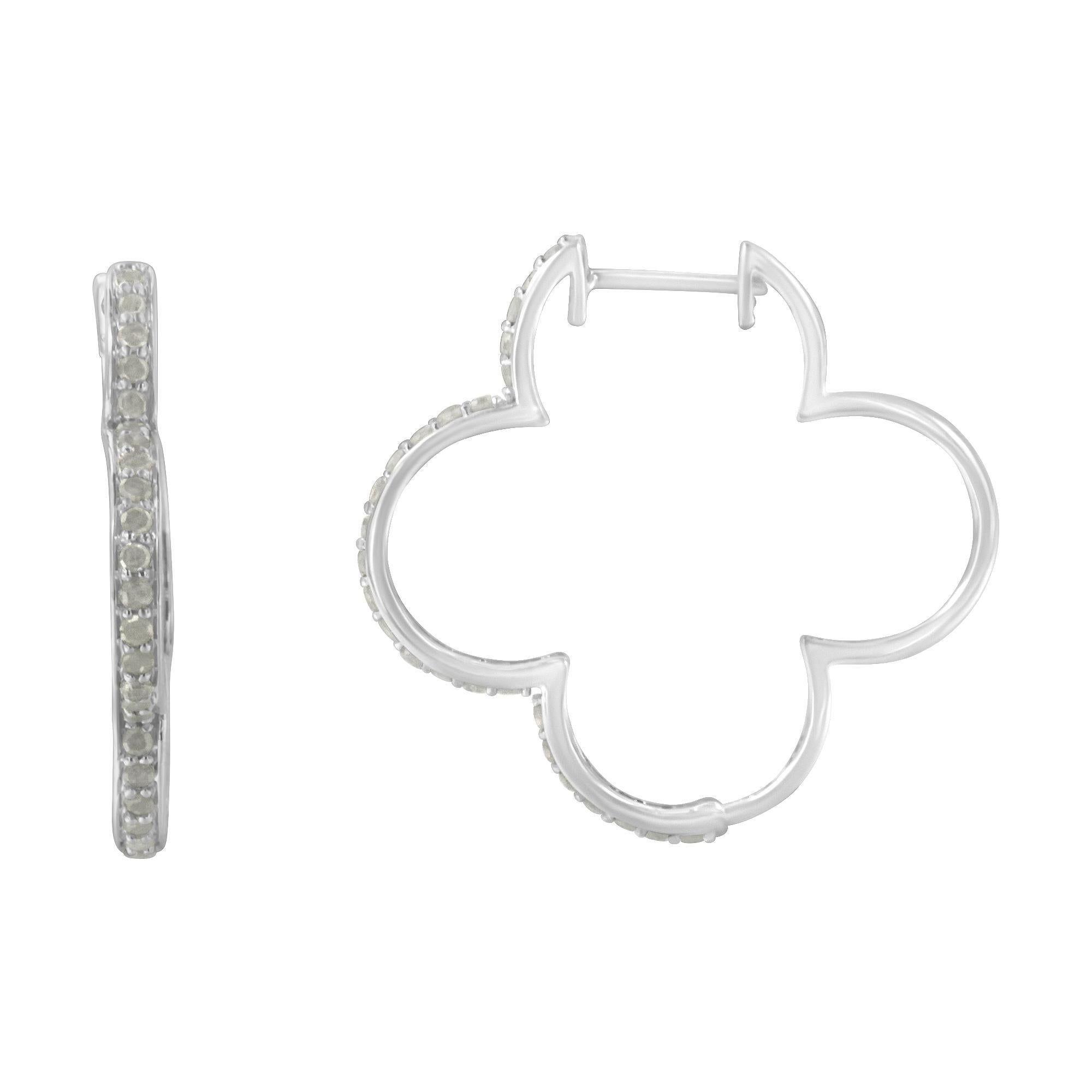 Elegant and timeless, these gorgeous sterling silver diamond hoop earrings feature 1.0 carat total weight of round diamonds. Each quatrefoil, clover shaped hoop earring is set with stones down the front. The round diamonds are each set in shared