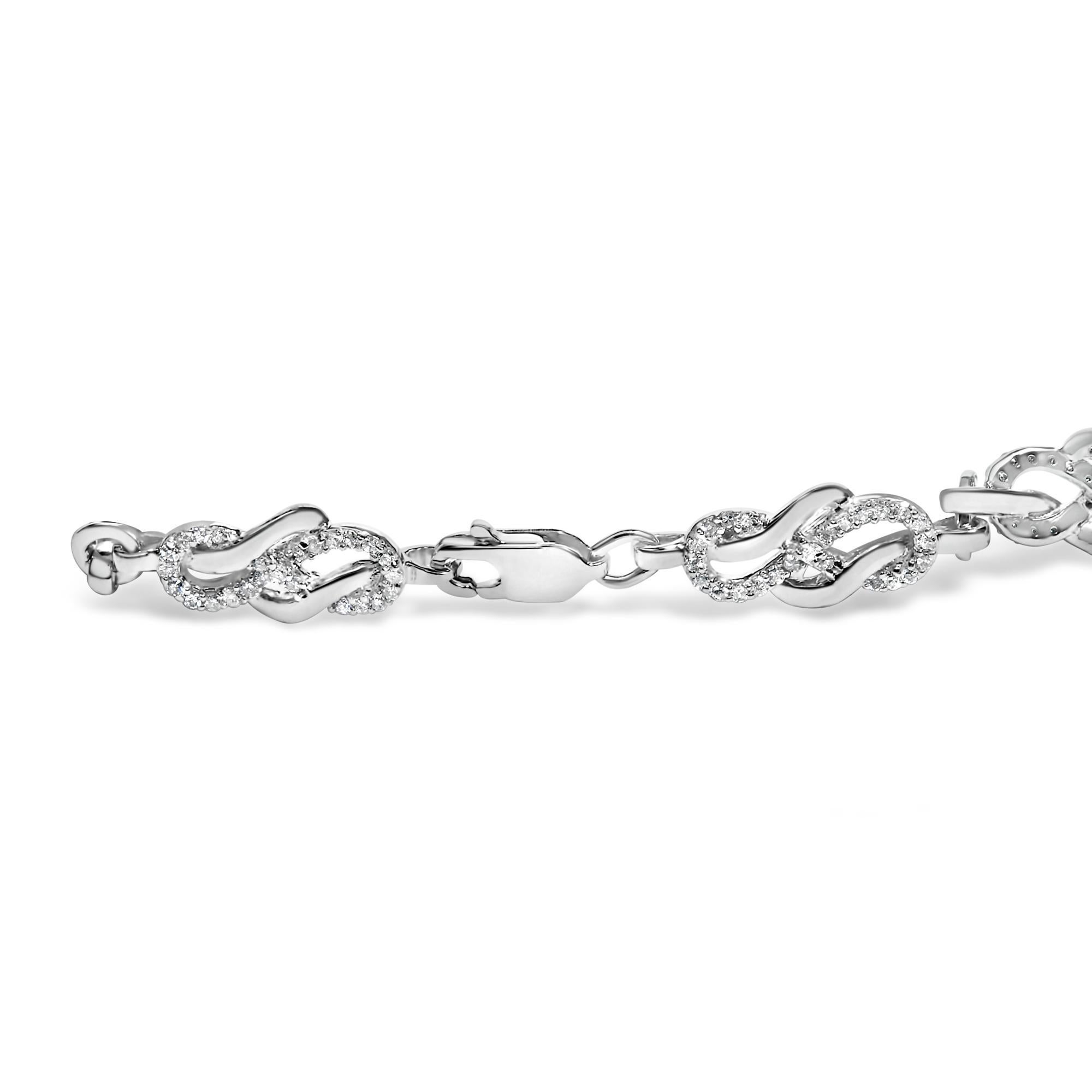 Immerse yourself in the enchanting allure of this exquisite .925 sterling silver bracelet, where elegance intertwines with timeless sophistication. Rhodium-plated for an enhanced lustrous sheen and additional strength, this captivating 7.25-inch
