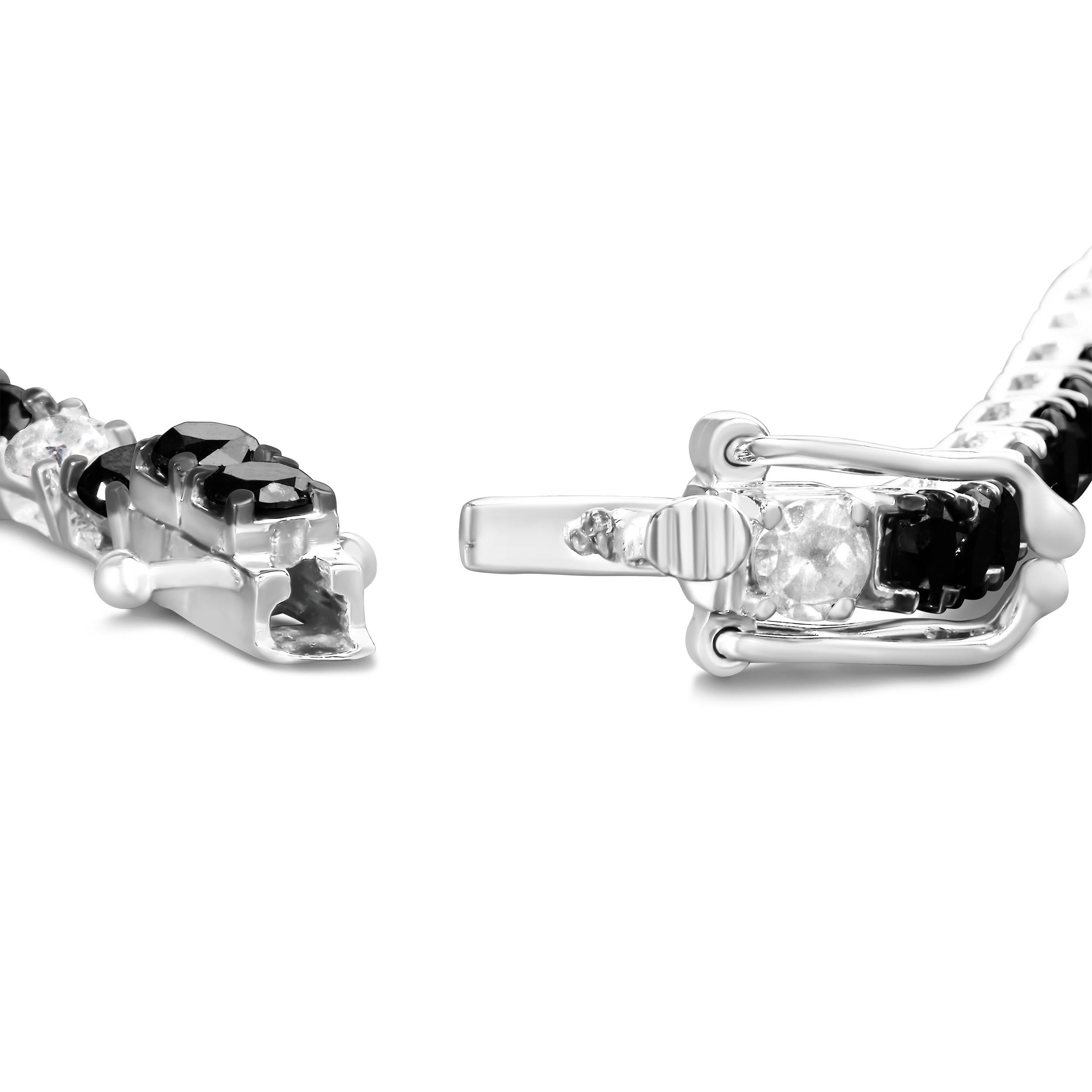 Elevate your style with this striking .925 sterling silver tennis bracelet, featuring a dazzling 10.0 carats of natural diamonds. Alternating between the brilliance of white diamonds and the rich, vivid tones of color-treated black diamonds, this