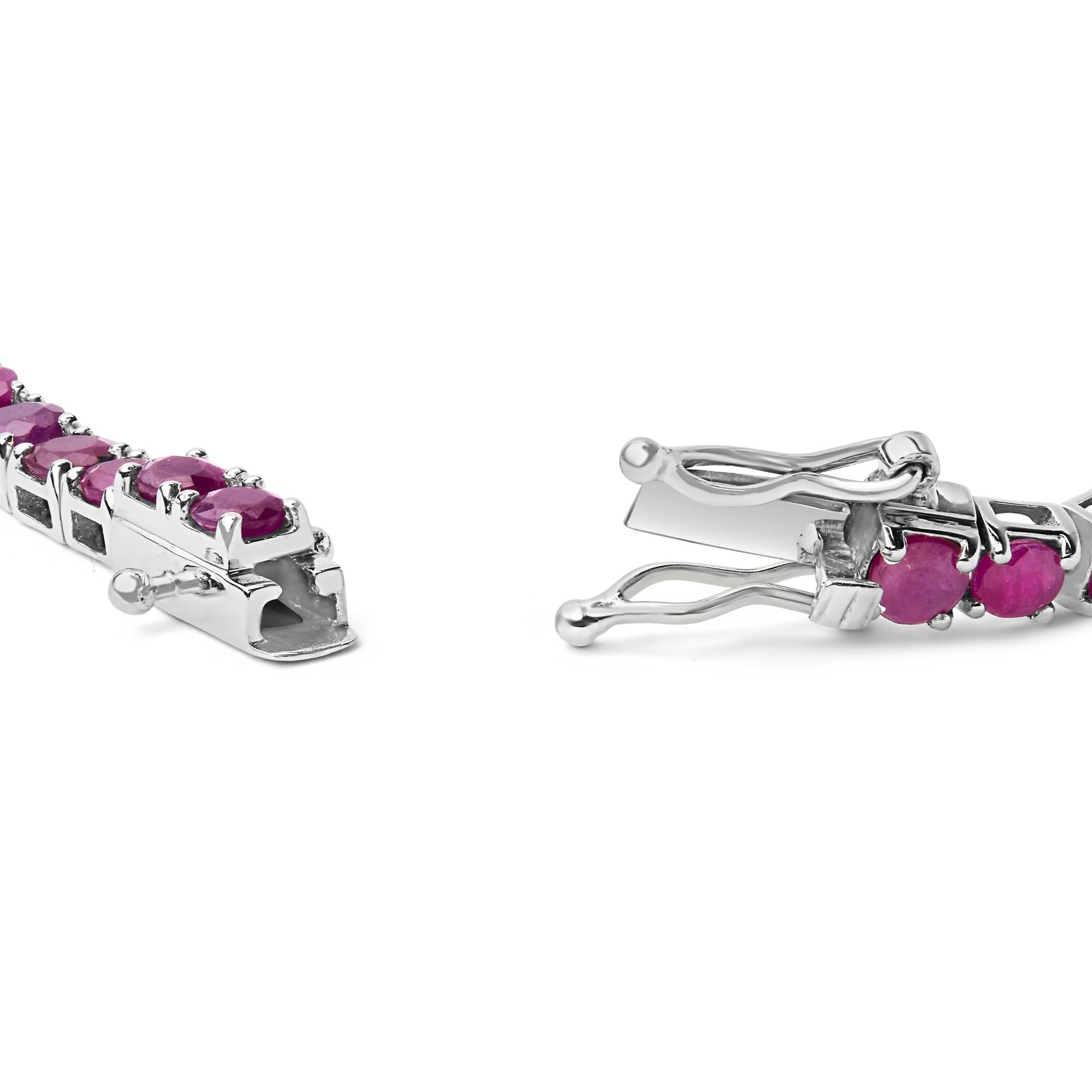 Drape your wrist in a ribbon of sumptuous pink with this exquisite 11 1/2 carat tennis bracelet, meticulously crafted from rhodium-plated .925 sterling silver. Each lab-created ruby, vivid in its lush dark pink hue, has undergone careful color